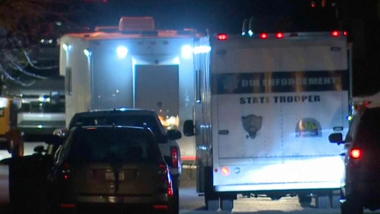 In this grab taken from video, emergency services work at a scene of a helicopter crash in Flagstaff, Arizona, Thursday. A public safety helicopter responding to a shootout between police and a suspect crashed, killing the pilot and a trooper.
