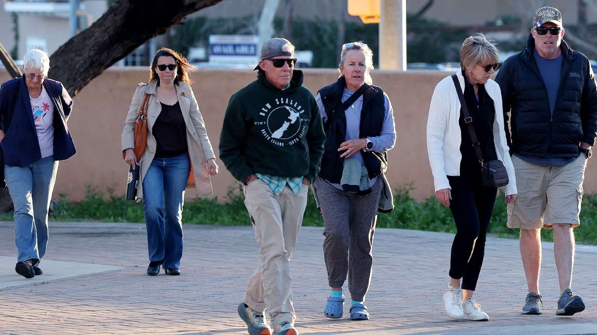 A group of people walk up to St. Philip's in the Hills Episcopal Church to attend the candlelight service for Nancy Guthrie, the 84-year-old mother of NBC "Today" show host Savannah Guthrie in Tucson, Ariz. on Wednesday. There has been no public sign of a response to Savannah Guthrie's message to her mother's kidnapper.