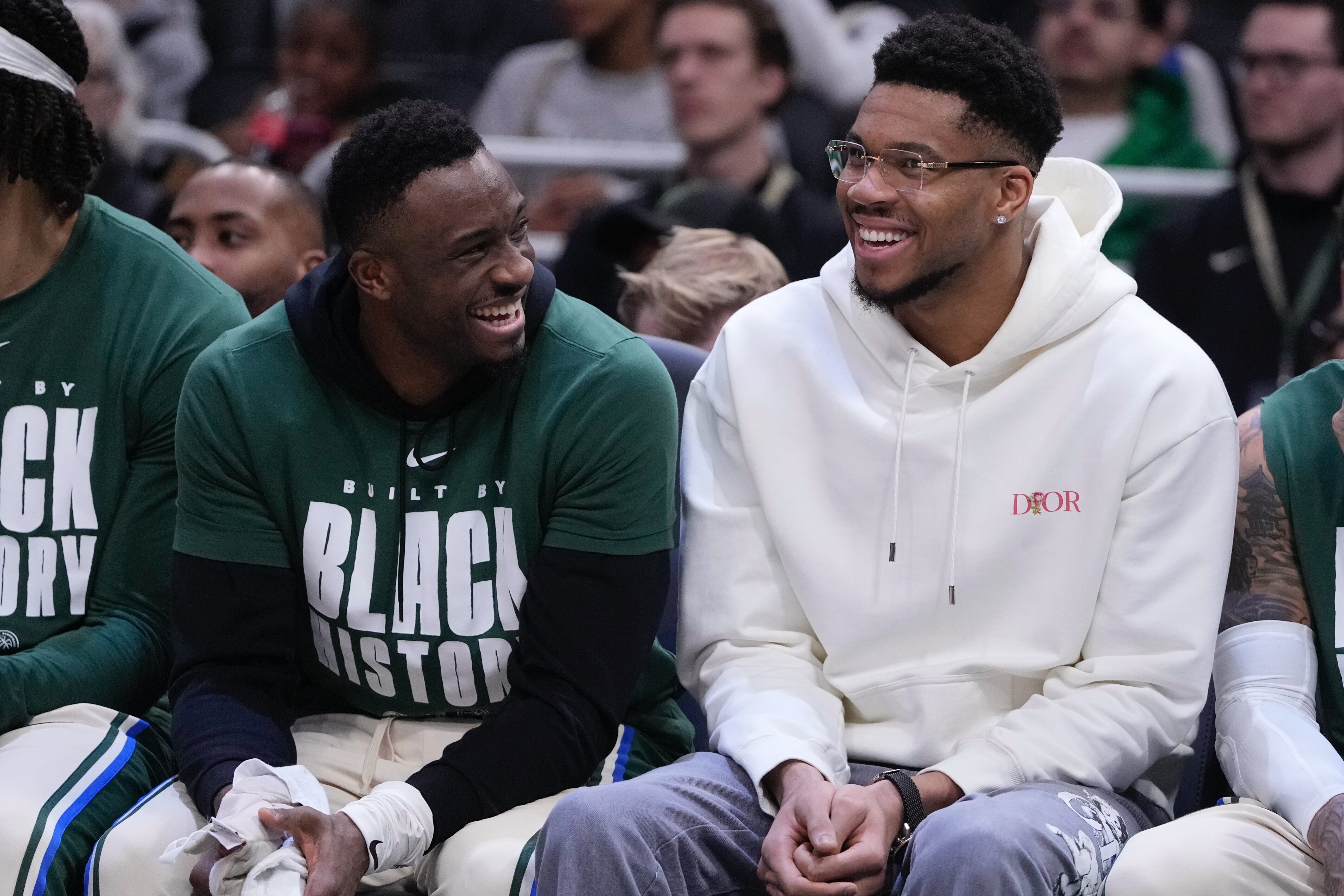 Milwaukee Bucks' Giannis Antetokounmpo smiles on the bench with Thanasis Antetokounmpo during the first half of an NBA basketball game Wednesday, Feb. 4, 2026, in Milwaukee. 
