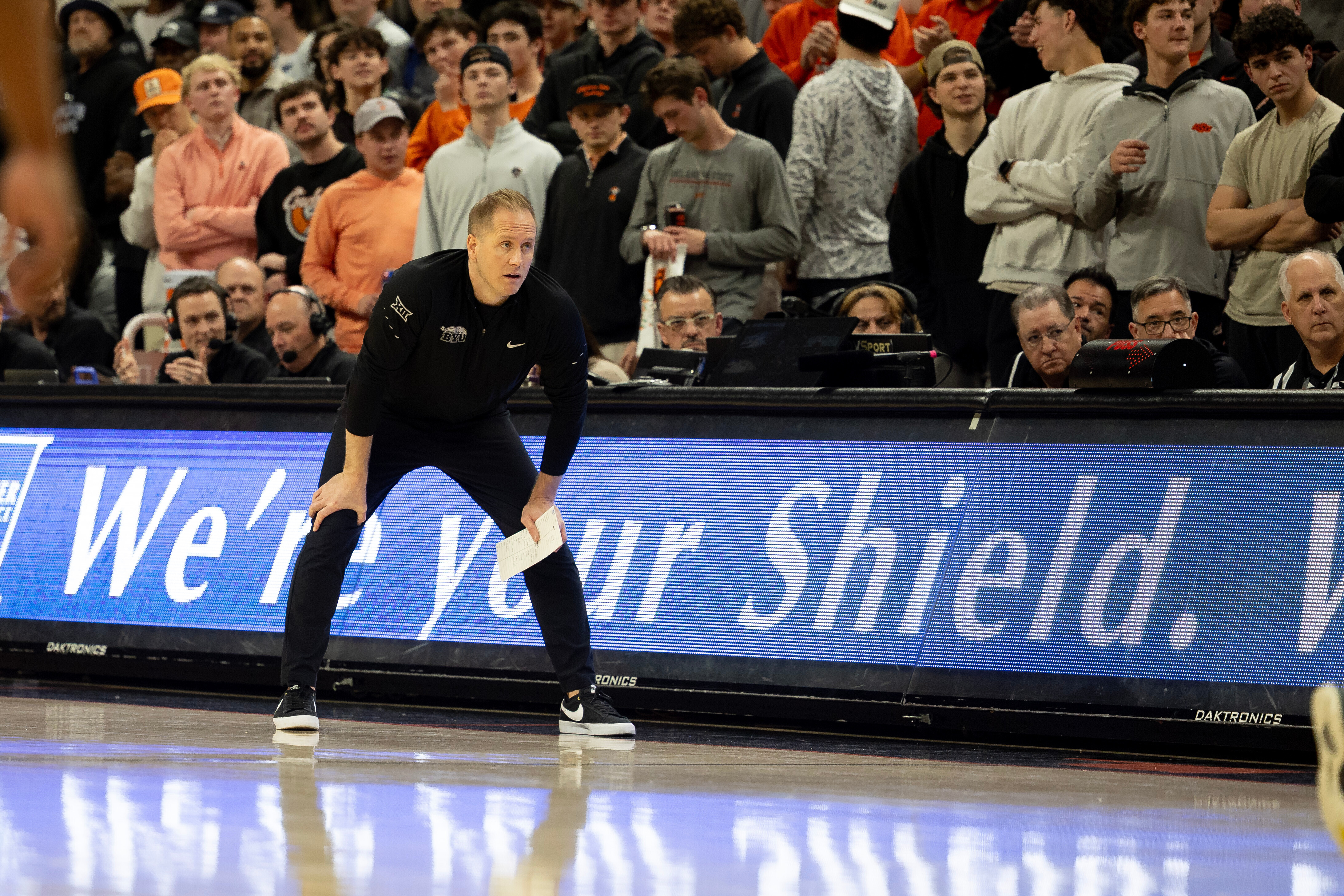 BYU head coach Kevin Young stands on the baseline in the first half of an NCAA college basketball game against Oklahoma State, Wednesday, Feb. 4, 2026 in Stillwater, Okla.