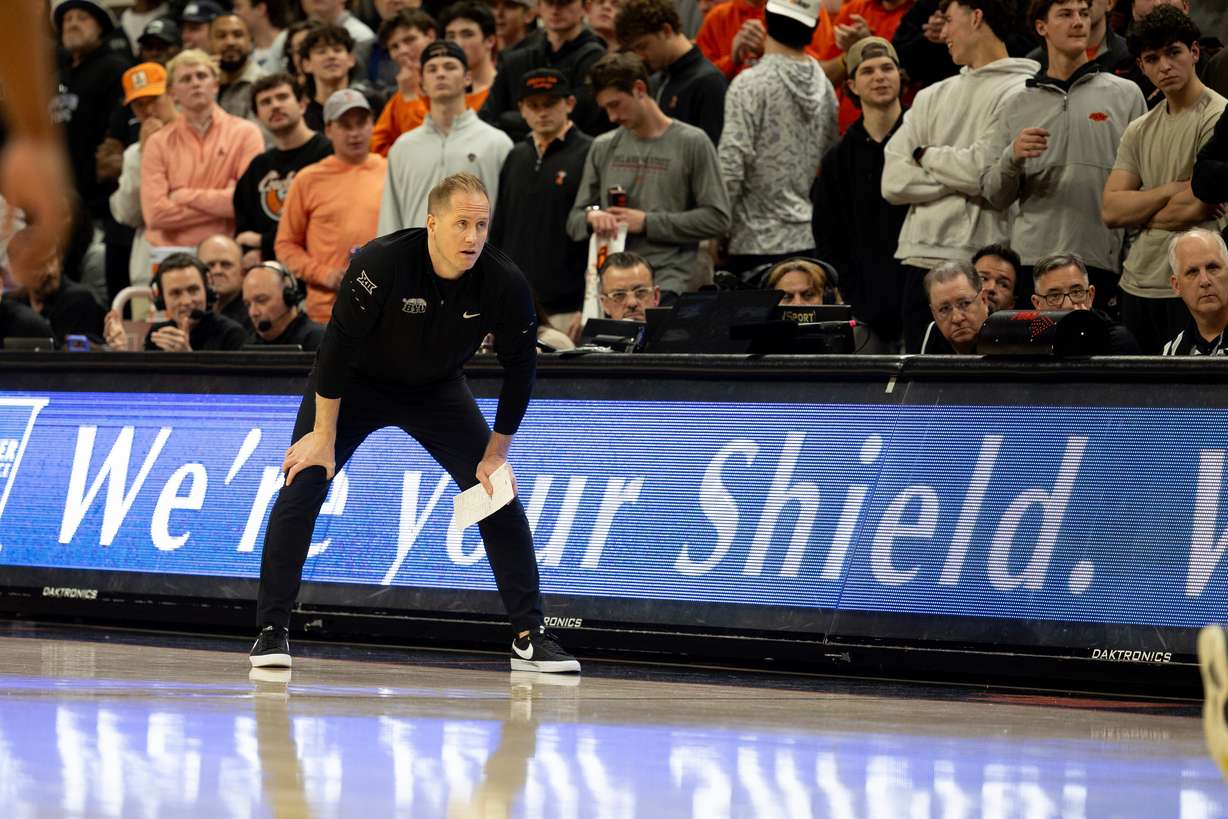 BYU head coach Kevin Young stands on the baseline in the first half of an NCAA college basketball game against Oklahoma State, Wednesday, Feb. 4, 2026 in Stillwater, Okla.