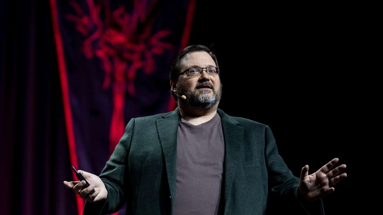 Brandon Sanderson speaks during a release event for his upcoming book, "Tailored Realities," during Dragonsteel Nexus at the Salt Palace Convention Center in Salt Lake City on Dec. 4. Sanderson outlined what a recent deal with Apple TV meant for him.