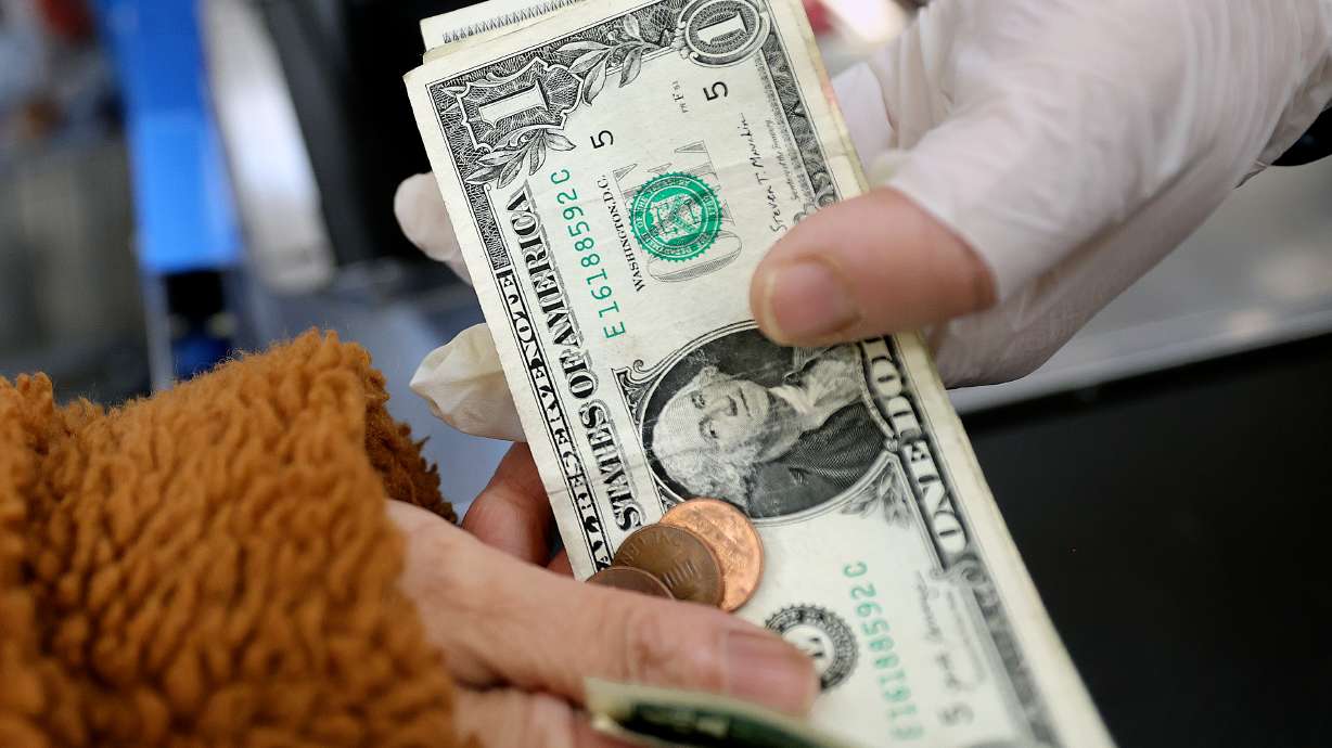 A customer and cashier exchange money at a Walmart Supercenter in West Valley City on Oct. 31, 2025. For the third consecutive month, Utah's consumer sentiment ticked upwards with a modest 0.9% increase in January.