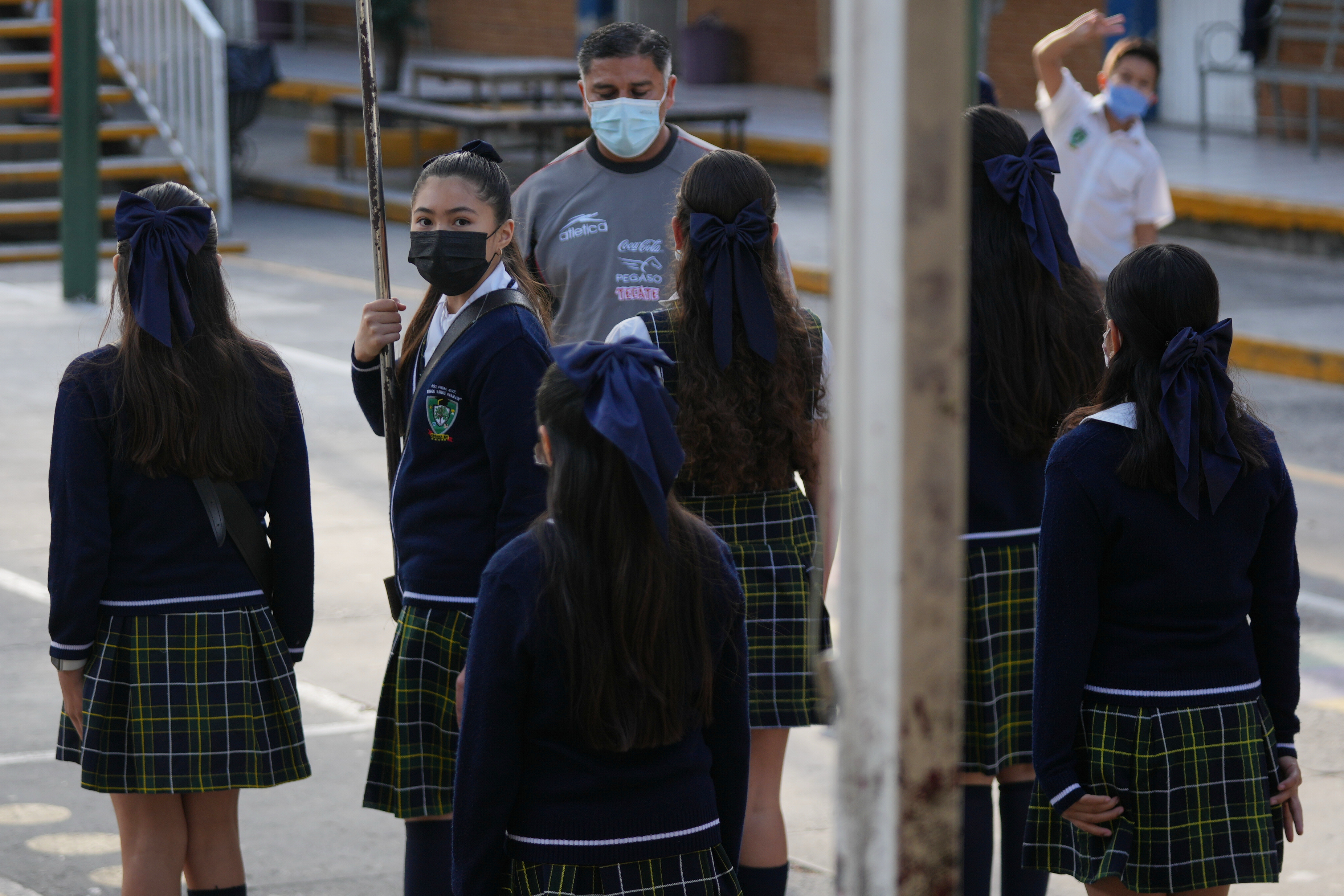 Public school students and teachers wear mandatory face masks amid a measles outbreak, during a ceremony at their school in Guadalajara, Mexico, Thursday, Feb. 5, 2026. 