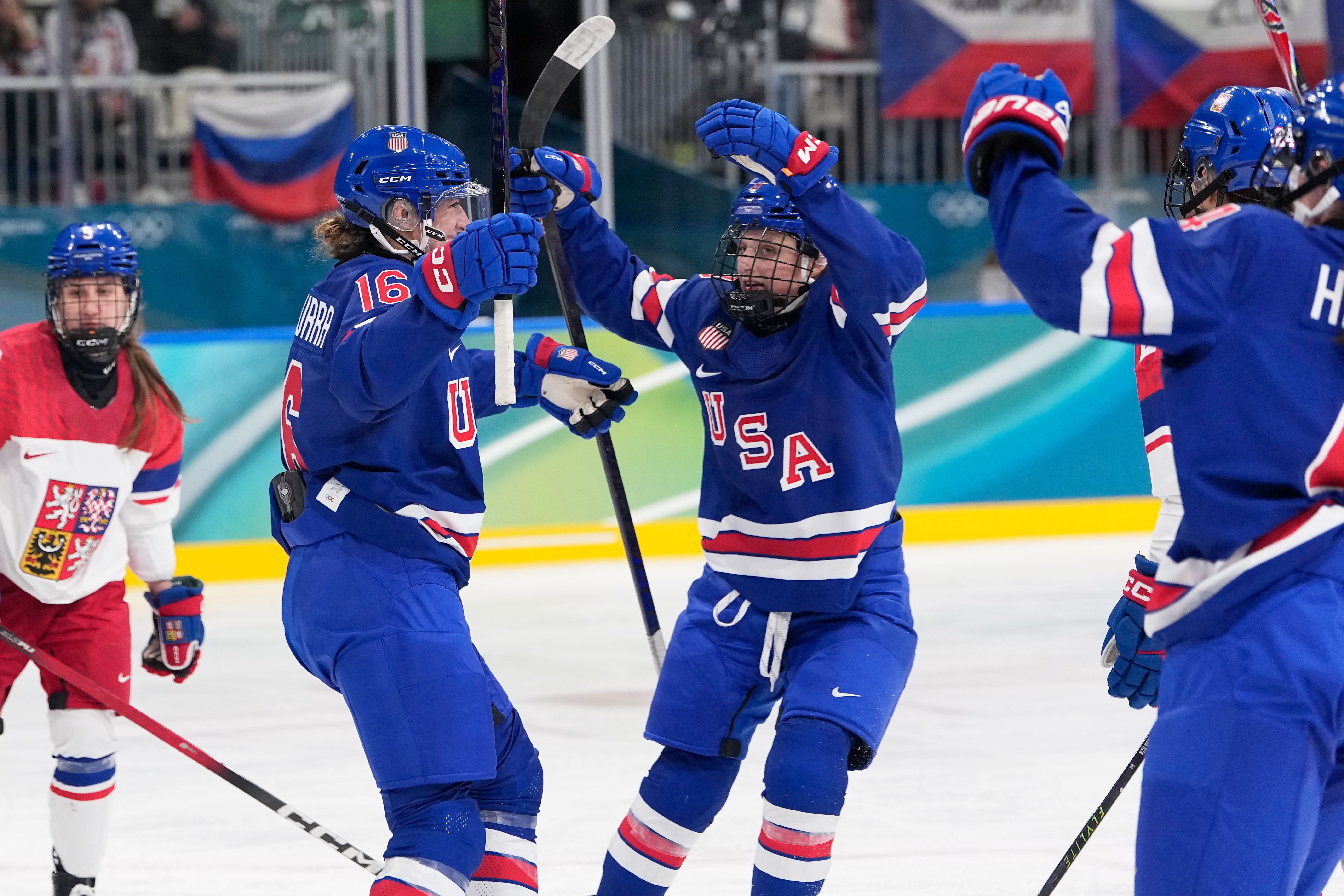 United States' Hayley Scamurra, left, celebrates with teammates after scoring her sides fifth goal during a preliminary round match of women's ice hockey between United States and Czechia at the 2026 Winter Olympics, in Milan, Italy, Thursday, Feb. 5, 2026. 