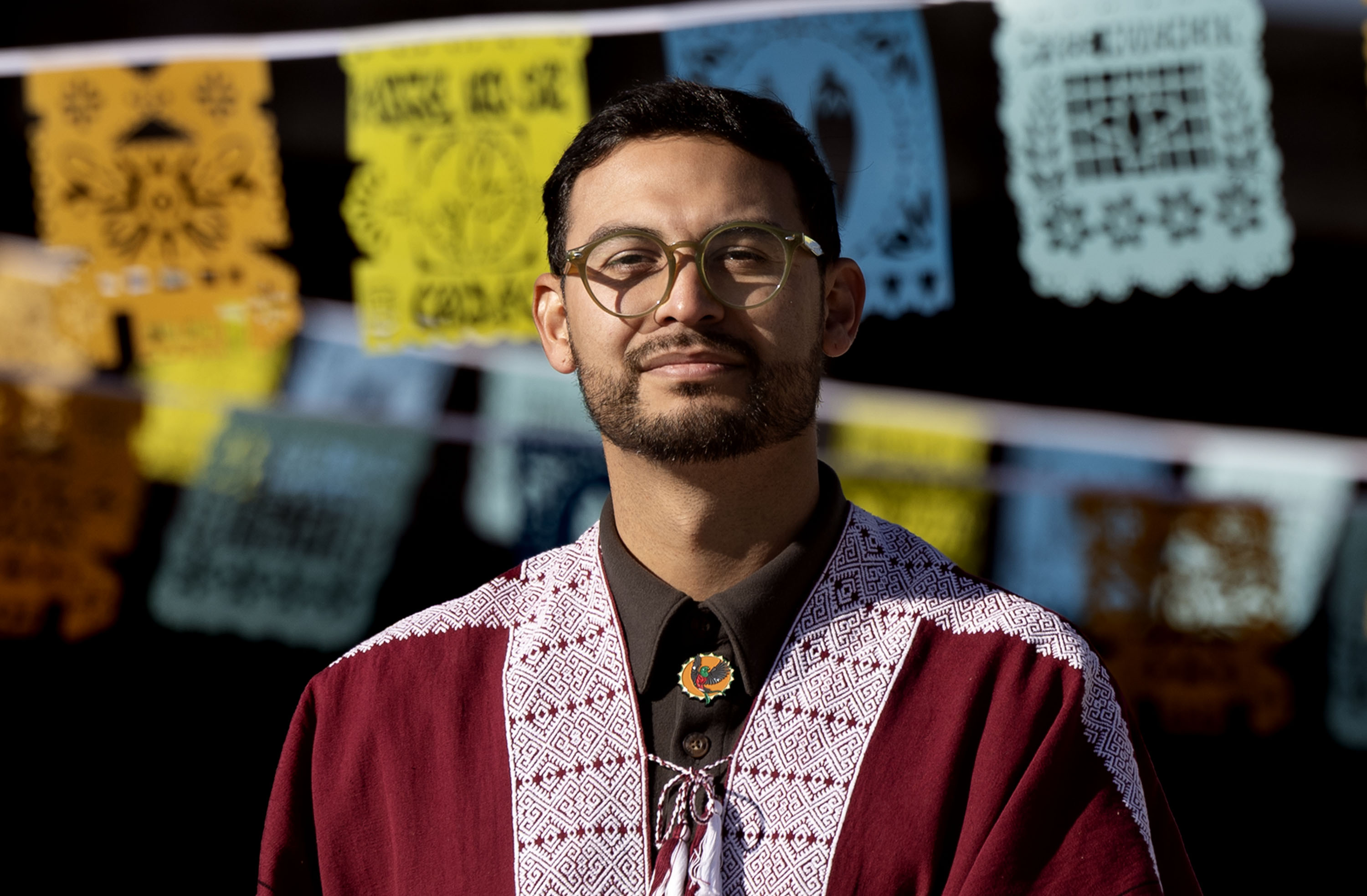 Luis Novoa, executive director of Artes de Mexico en Utah, at a community-created art installation at the intersection of 900 South and 600 West in Salt Lake City on Thursday. Voces al Vineto is a half-mile of papel picado (perforated paper), a traditional Mexican folk art, stretched across the west-east divide of I-15 and the rail tracks, created by Novoa and Artes de Mexico en Utah.