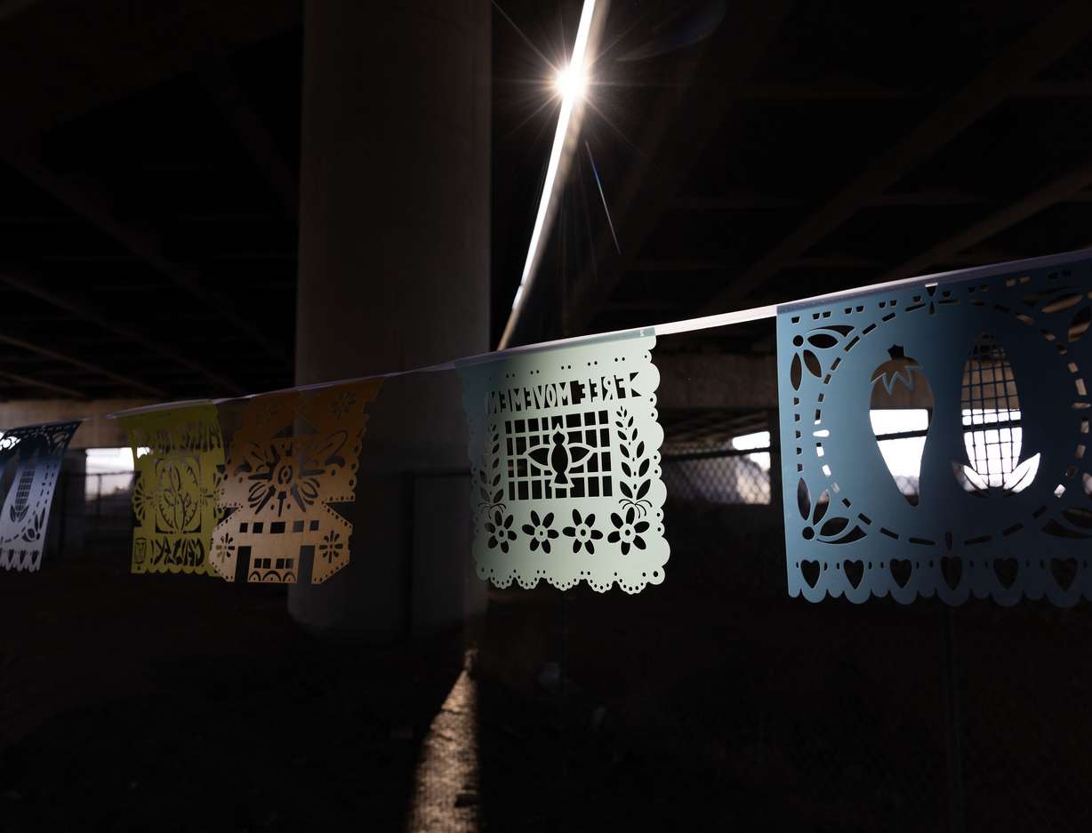 A community-created art installation hangs along the intersection of 900 South and 600 West in Salt Lake City on Thursday. Voces al Vineto is a half-mile of papel picado (perforated paper), a traditional Mexican folk art, stretched across the west-east divide of I-15 and the rail tracks, created by Artes de Mexico en Utah.