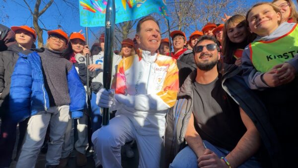 Utah 2034 Chairman Fraser Bullock runs Olympic torch in Milan, inspires thousands of students