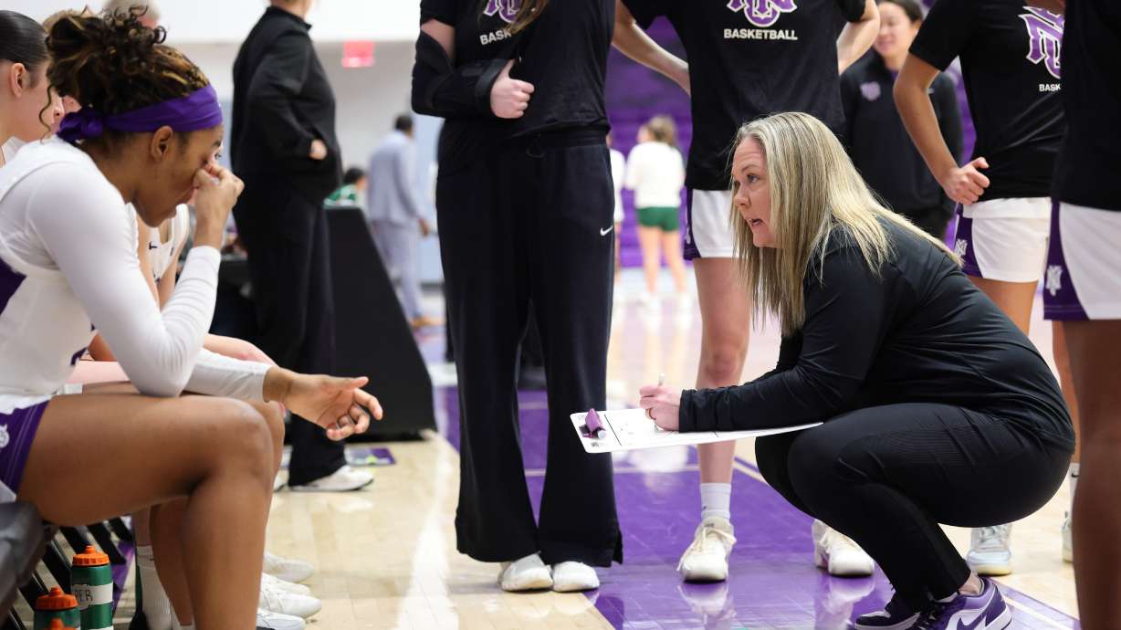 This photo provided by NYU Athletic Communications shows NYU coach Meg Barber, right, talking to players on her team Sunday, Feb. 1, 2026.