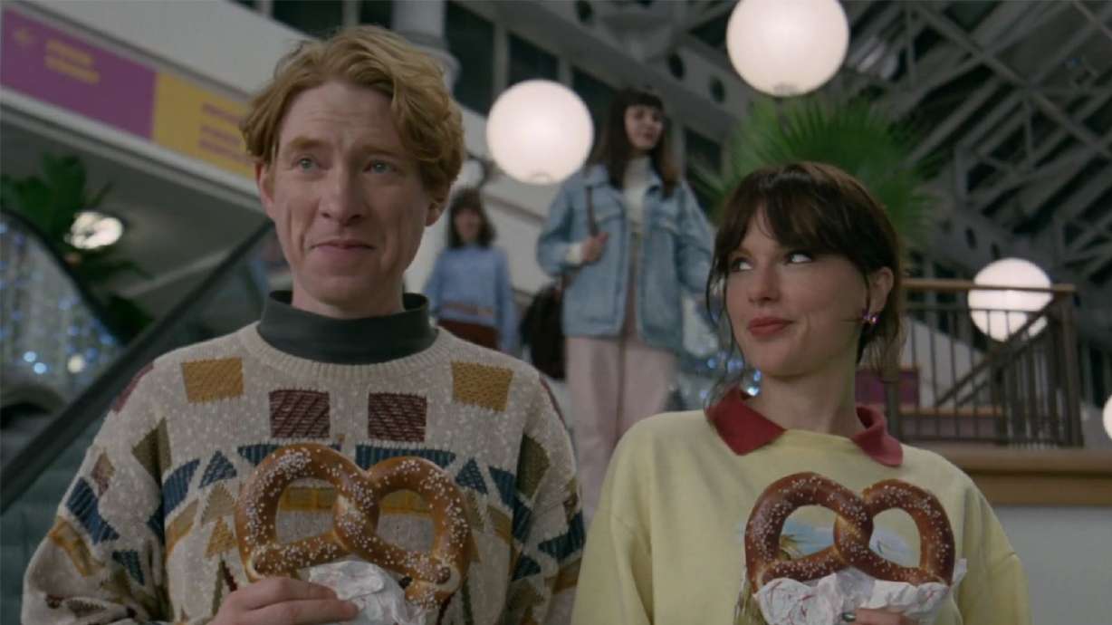 Domhnall Gleeson and Taylor Swift appear in Swift’s “Opalite” music video. Gleeson is one of many celebrities who appear in the video, released on Friday.