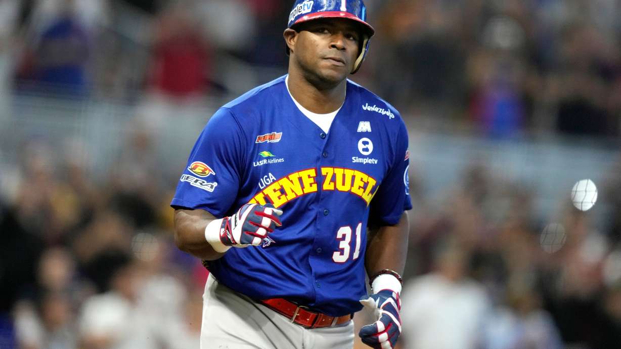 FILE - Venezuela's Yasiel Puig heads to first after drawing a bases loaded walk to score Ehire Adrianza during the third inning of a Caribbean Series baseball game against Curacao, Saturday, Feb. 3, 2024, in Miami.