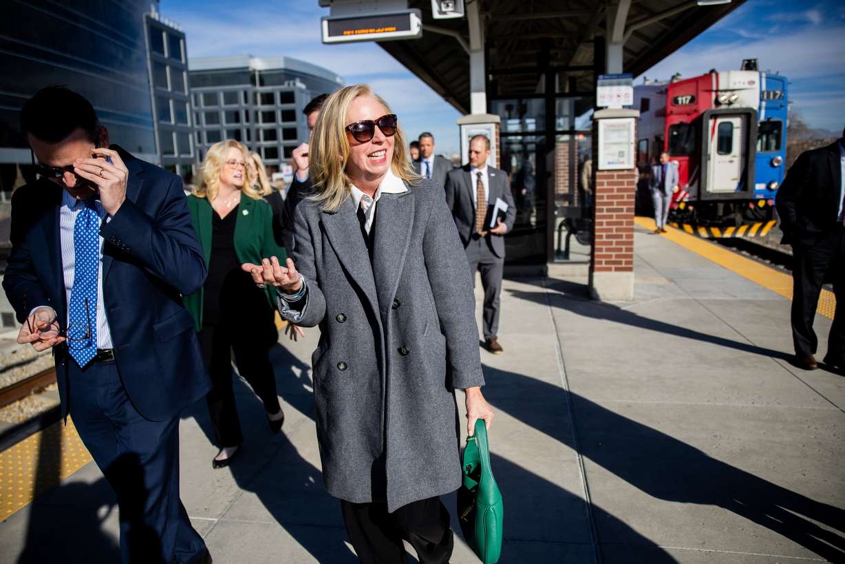 Beth Holbrook, member of the Utah Transit Authority board of trustees, center, exits the FrontRunner before a press conference to discuss the Surface Transportation Reauthorization at the South Jordan Station in South Jordan on Friday, Feb. 6, 2026.