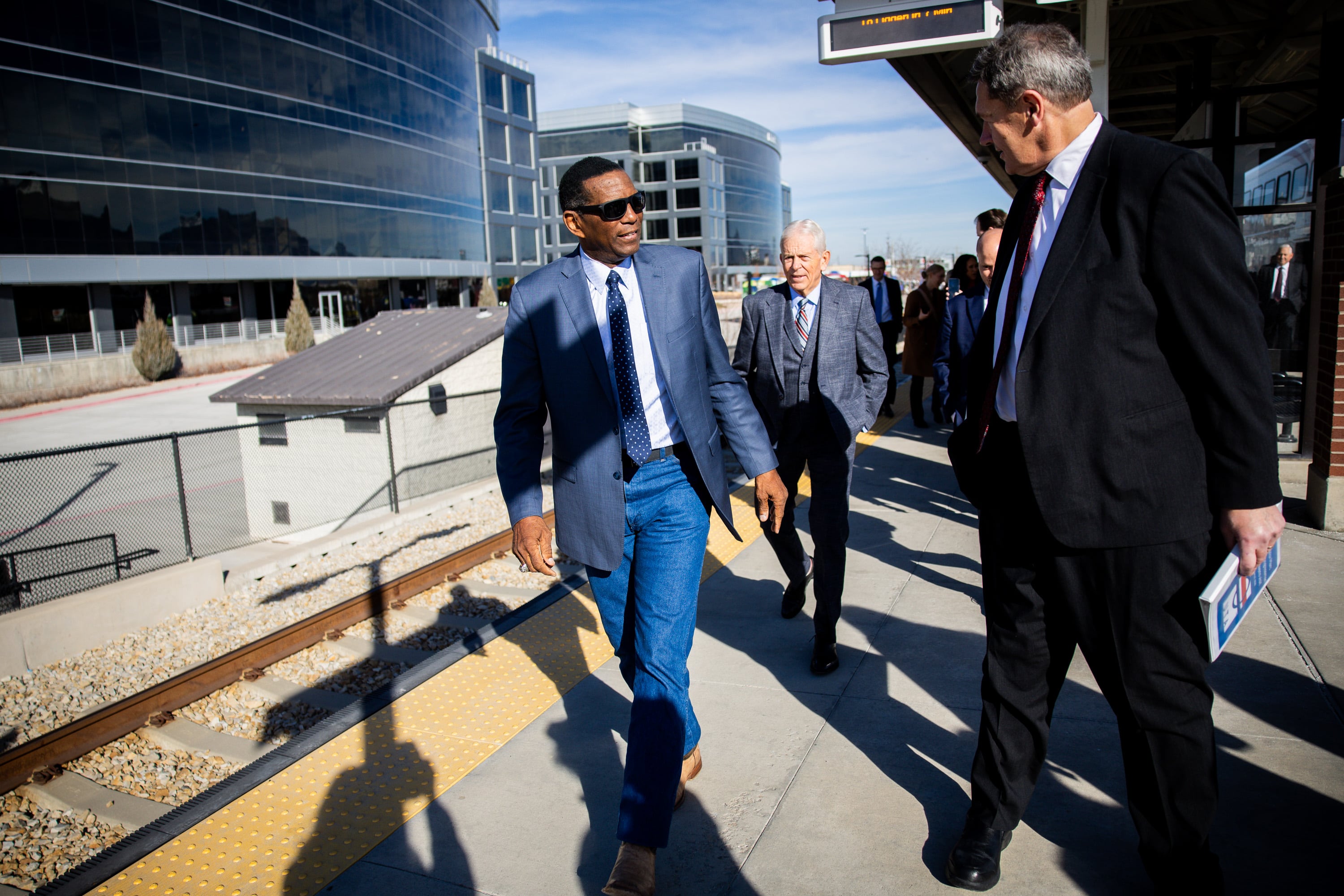 Rep. Burgess Owens, R-Utah, center, exits the FrontRunner before a press conference to discuss the Surface Transportation Reauthorization at the South Jordan Station in South Jordan on Friday.