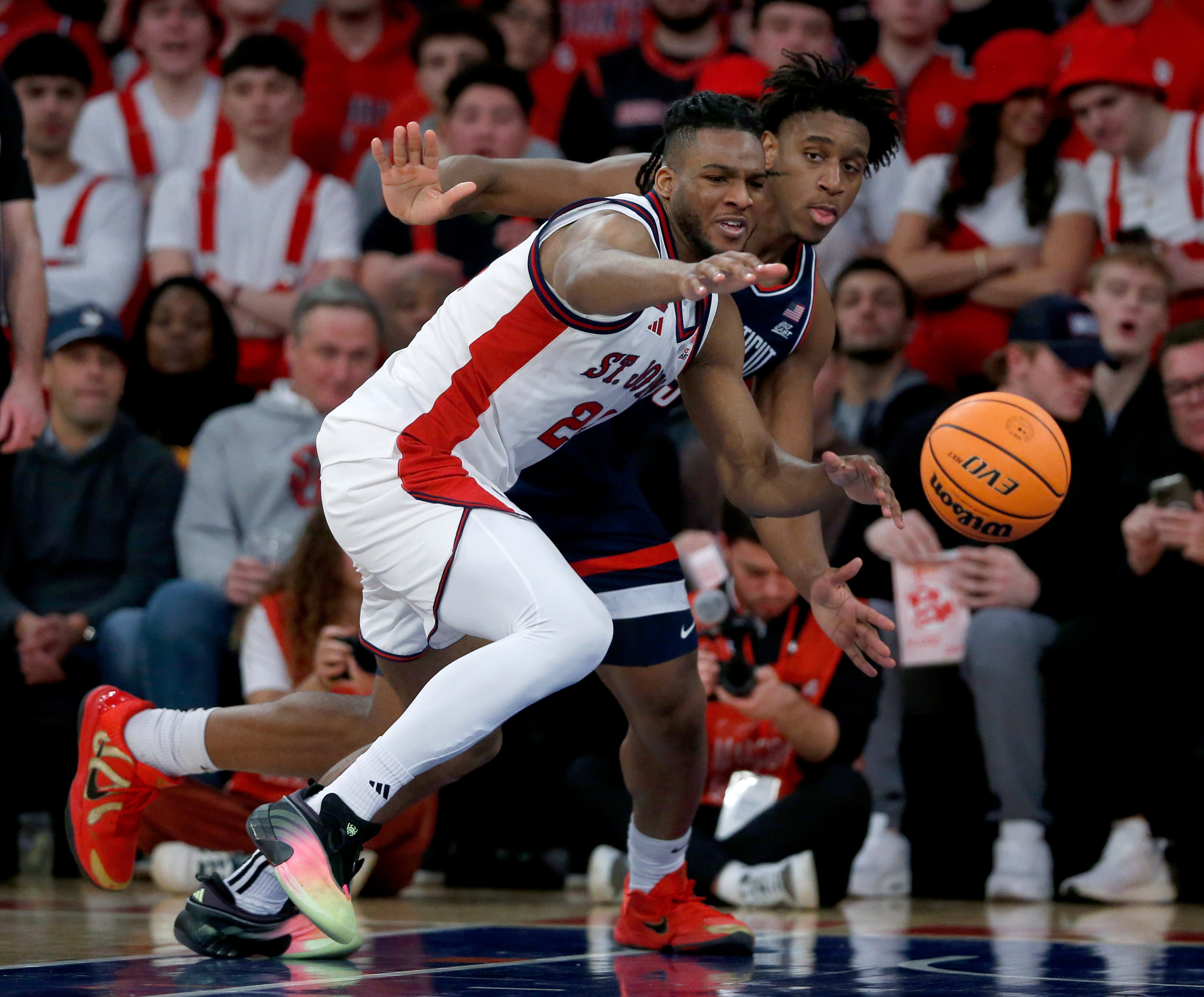 St. John's forward Zuby Ejiofor, left, and UConn center Tarris Reed Jr. battle for the ball during the first half of an NCAA college basketball game Friday, Feb. 6, 2026, in New York. 