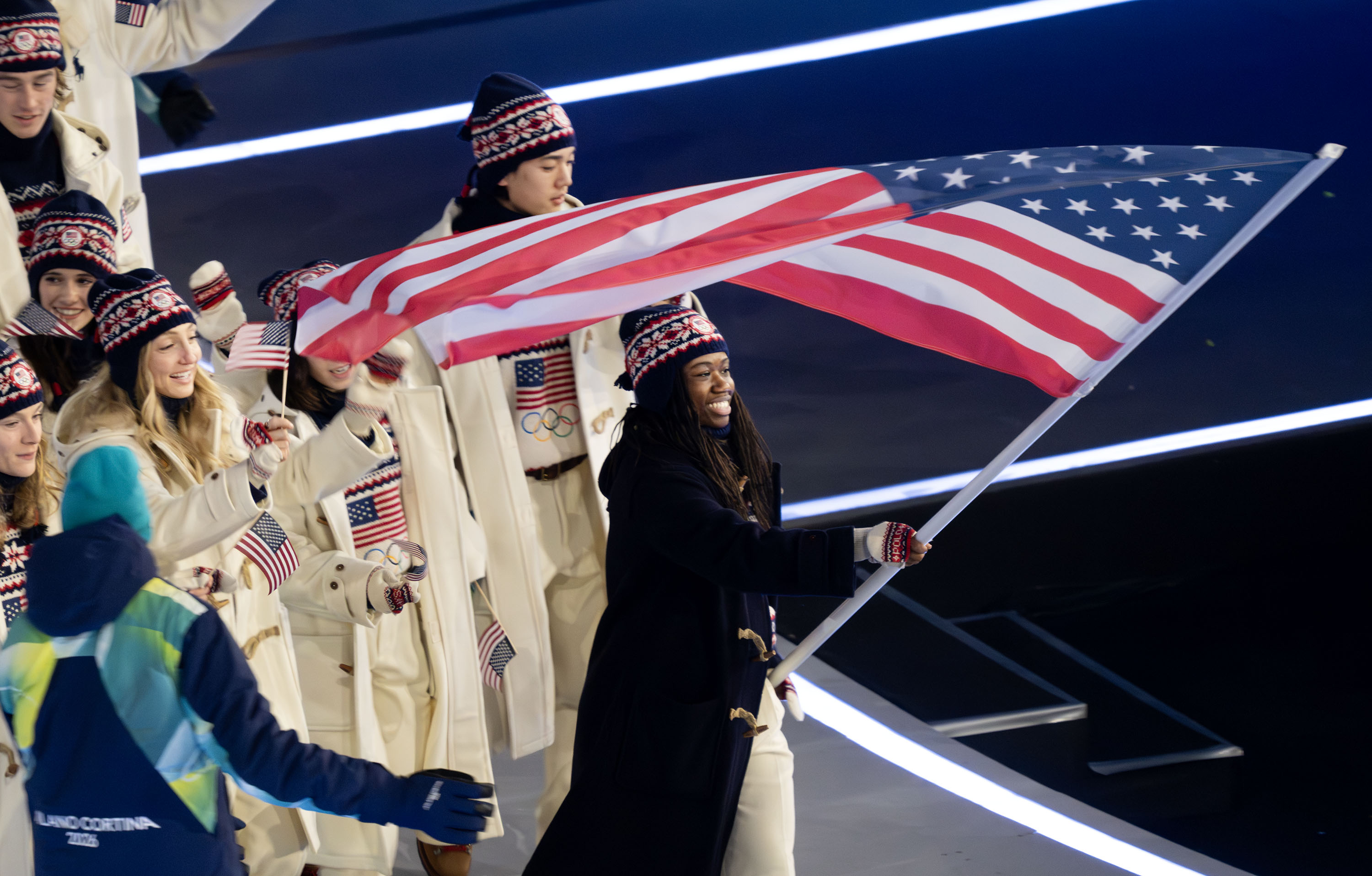 Flag bearer Erin Jackson of Team USA leads the team in the Parade of Athletes during the opening ceremonies of the 2026 Milan Cortina Winter Olympics in Milan, Italy, on Friday. Jackson, who trains in Utah, was greeted with loud cheers upon entering the stadium.
