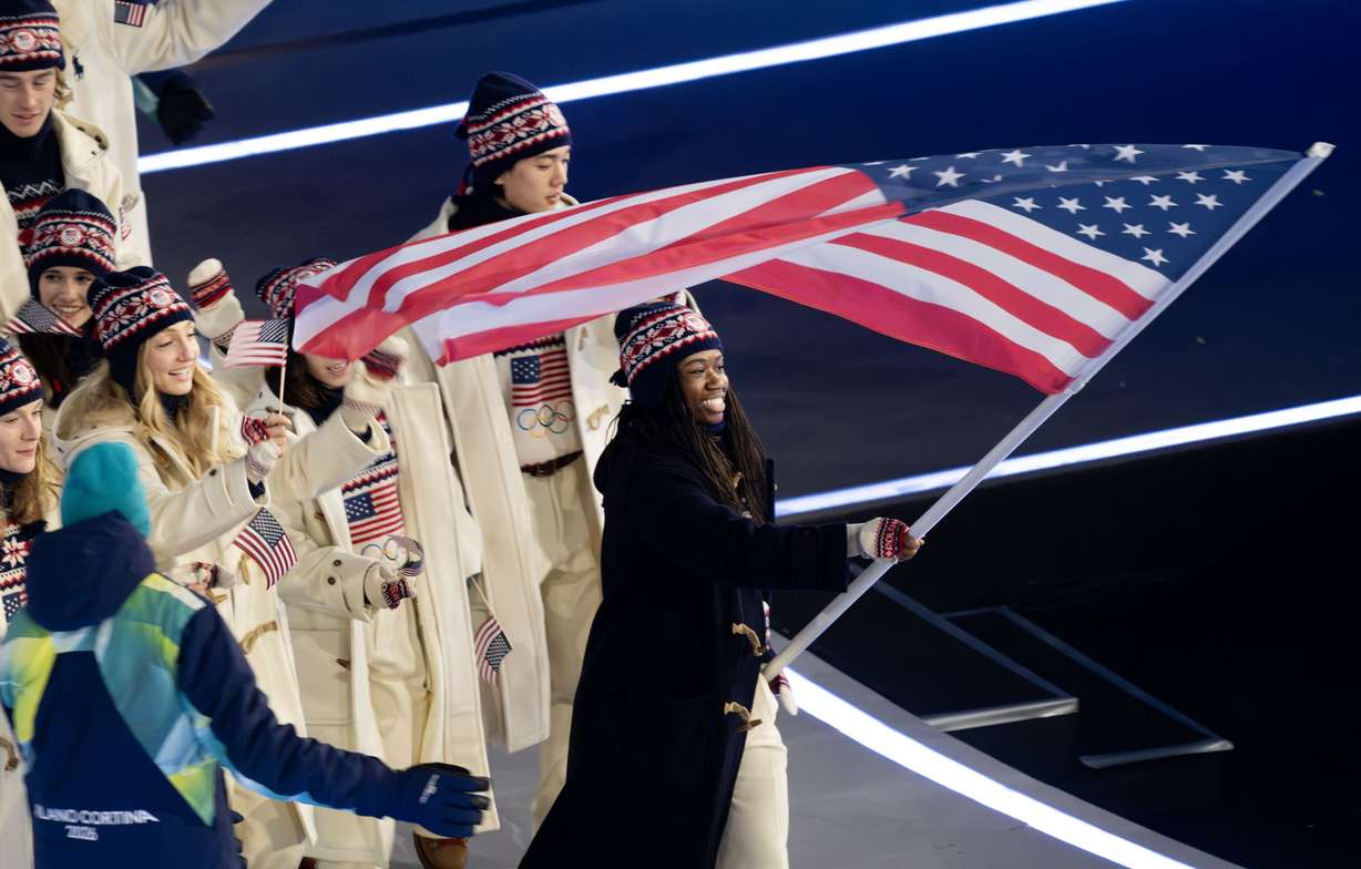Flag bearer Erin Jackson of Team USA leads the team in the Parade of Athletes during the opening ceremonies of the 2026 Milan Cortina Winter Olympics in Milan, Italy, on Friday. Jackson, who trains in Utah, was greeted with loud cheers upon entering the stadium.
