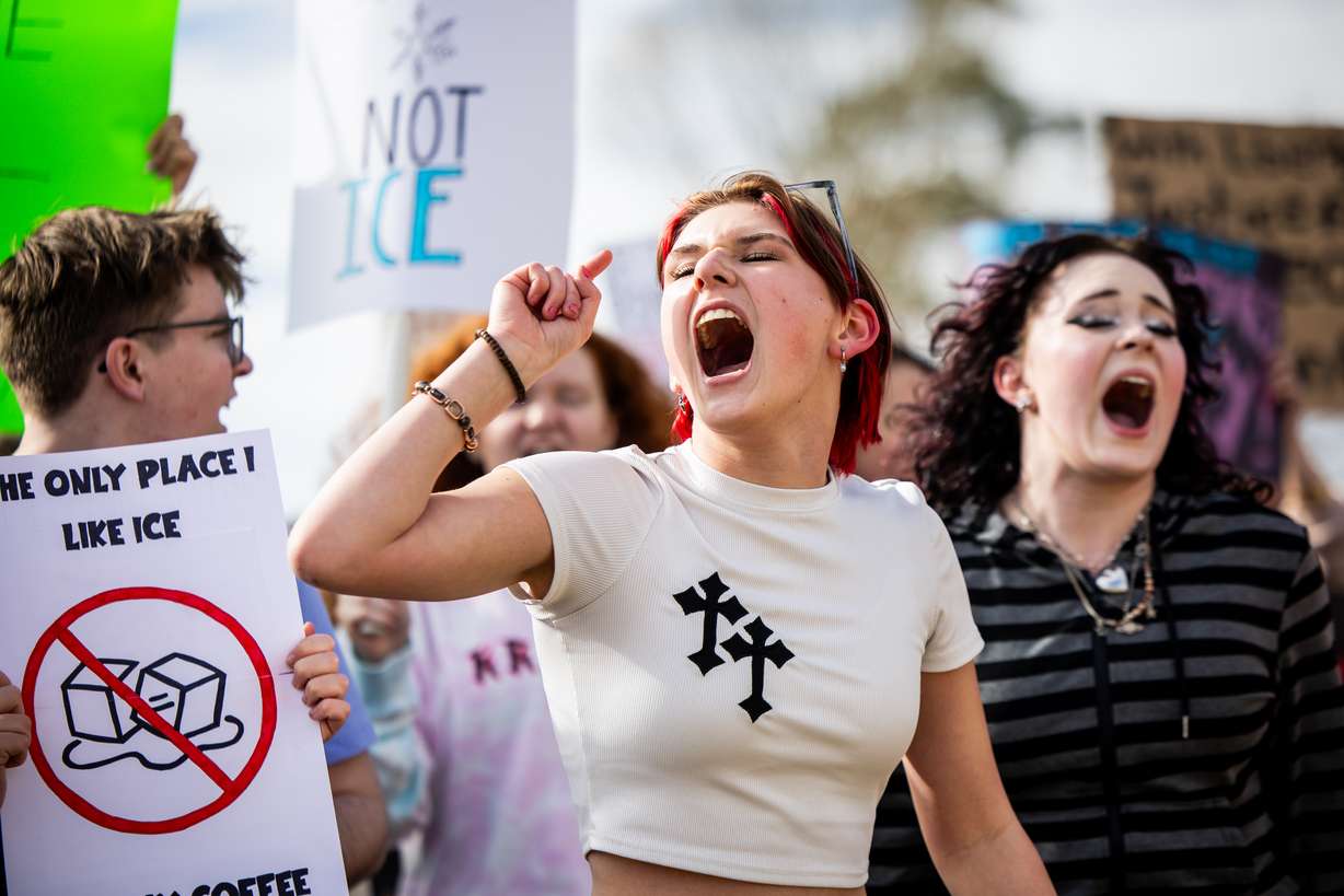 Corner Canyon High School student Ollie Hasenohrl, 16, center, participates in a walkout to protest ICE at Draper City Park in Draper on Friday.
