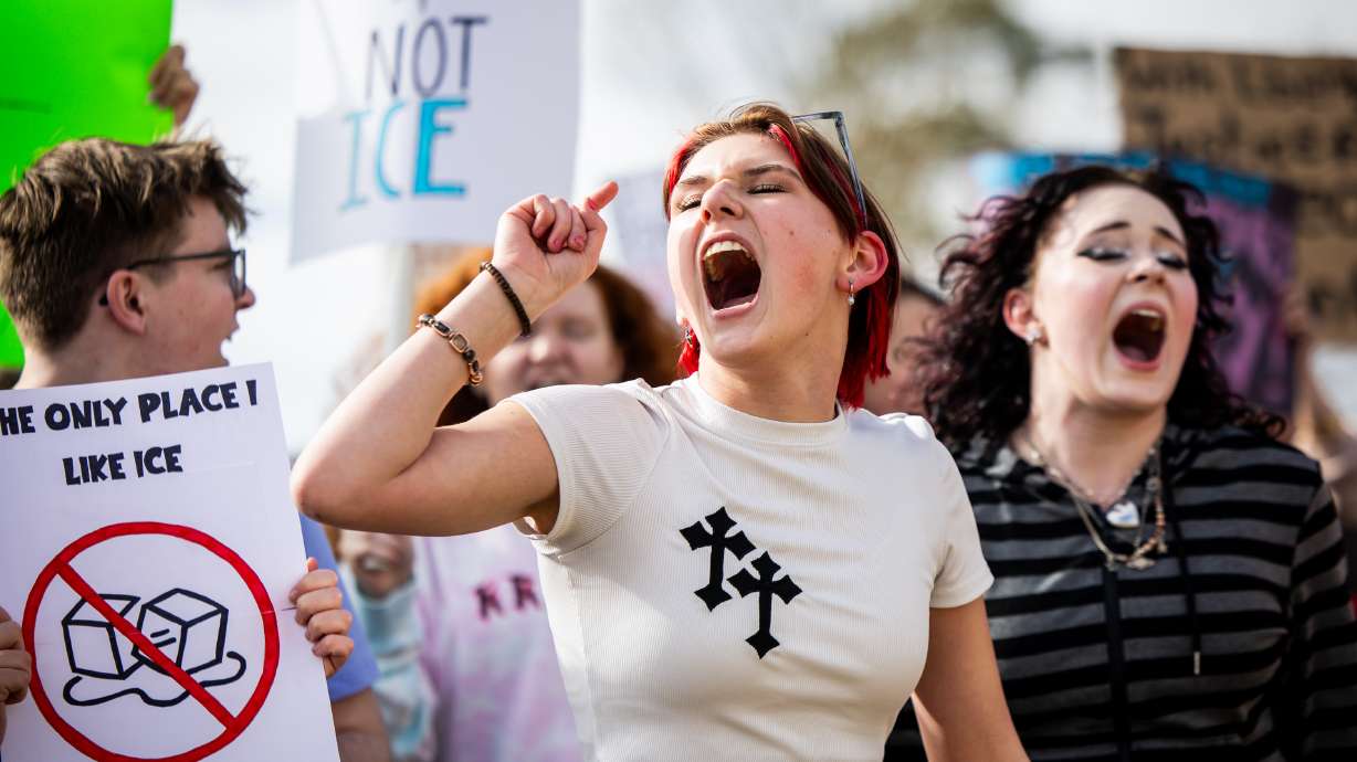 Corner Canyon High School student Ollie Hasenohrl, 16, center, participates in a walkout to protest ICE at Draper City Park in Draper on Friday.