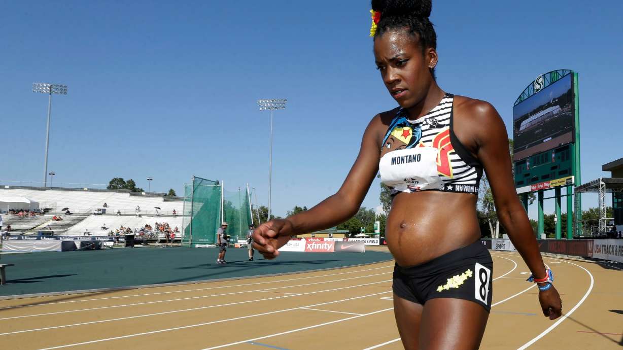 Alysia Montaño, who was five months pregnant at the time, walks to the starting line for a heat in the first round of the women's 800m at the US Track and Field Championships in Sacramento, California on June 22, 2017.