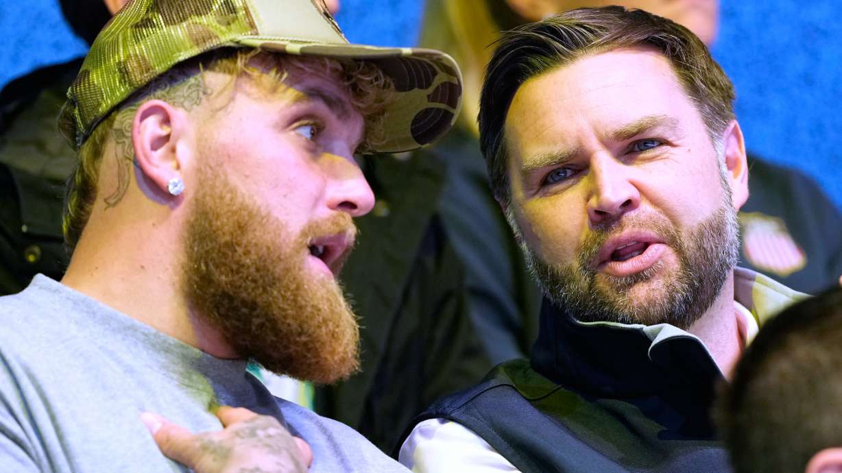 Jake Paul, left, and Vice President JD Vance attend a preliminary round match of women's ice hockey between the United States and Finland at the 2026 Winter Olympics, in Milan, Italy, Saturday, Feb. 7, 2026.