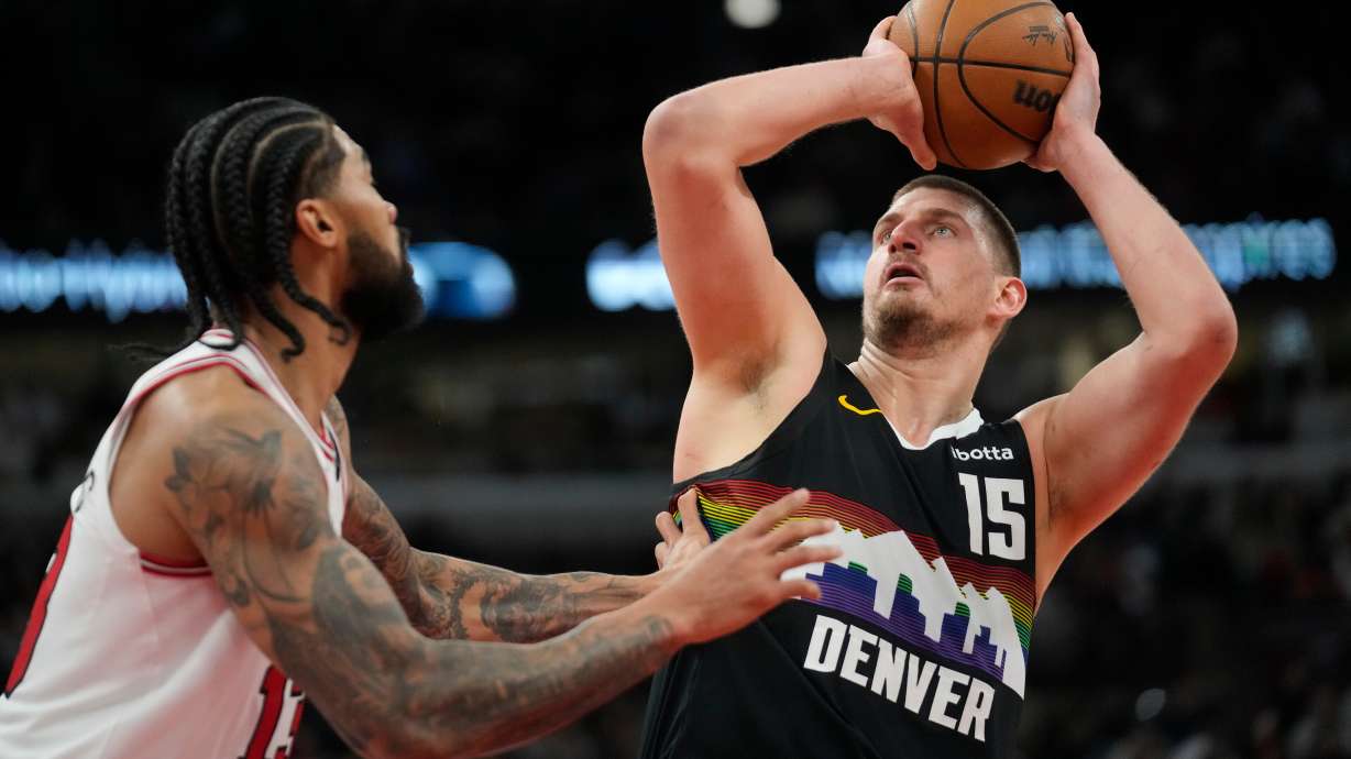 Denver Nuggets center Nikola Jokic (15), right, handles the ball as Chicago Bulls center Nick Richards (13) defends during the second half of an NBA basketball game Saturday, Feb. 7, 2026, in Chicago.
