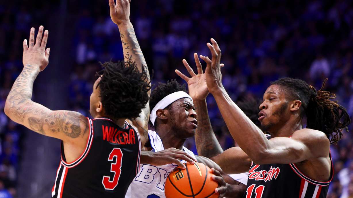 BYU forward AJ Dybantsa (3) is fouled as he drives to the basket during the first half of an NCAA basketball game against the Houston Cougars at the Marriott Center in Provo on Saturday, Feb. 7, 2026.