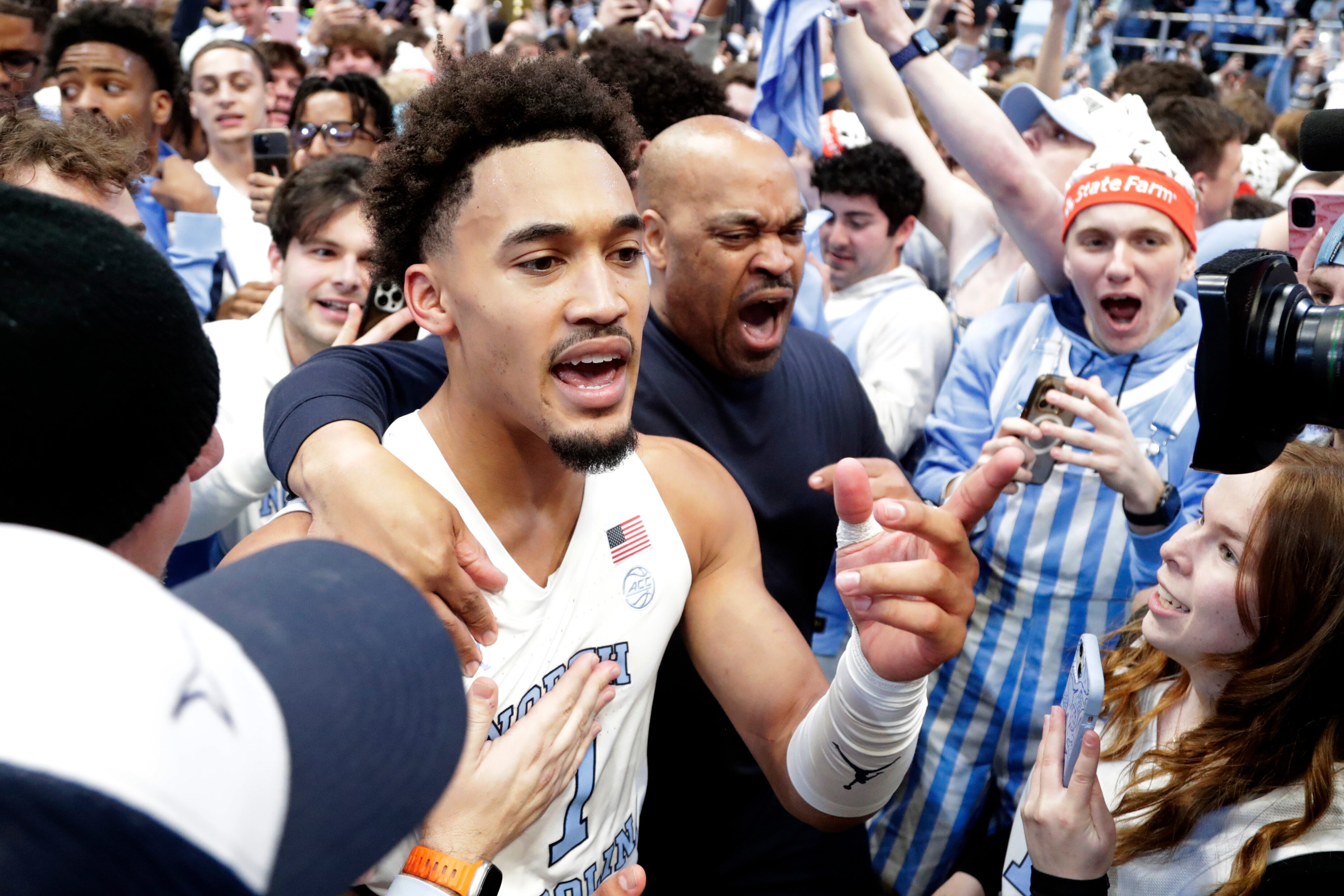 North Carolina guard Seth Trimble (7) celebrates with fans after an NCAA college basketball game against Duke, Saturday, Feb. 7, 2026, in Chapel Hill, N.C. 