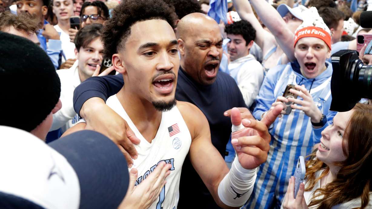North Carolina guard Seth Trimble (7) celebrates with fans after an NCAA college basketball game against Duke, Saturday, Feb. 7, 2026, in Chapel Hill, N.C.