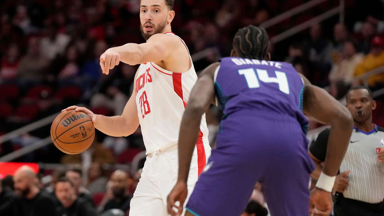 Houston Rockets center Alperen Sengun (28) looks to pass the ball against Charlotte Hornets forward Moussa Diabate (14) during the first half of an NBA basketball game, Thursday, Feb. 5, 2026, in Houston.