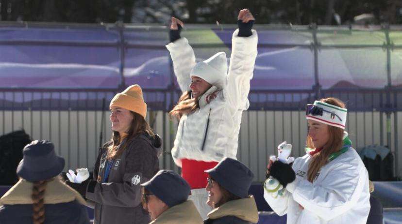 Breezy Johnson stands atop the podium in Cortina after winning gold in the women’s downhill.