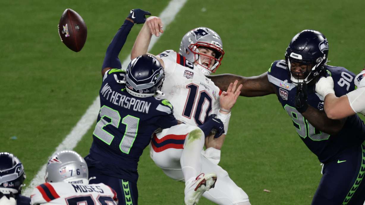 Seattle Seahawks cornerback Devon Witherspoon (21) forces a fumble against New England Patriots quarterback Drake Maye (10) at the NFL Super Bowl 60 game in Santa Clara, Calif., Sunday, February 8, 2026.
