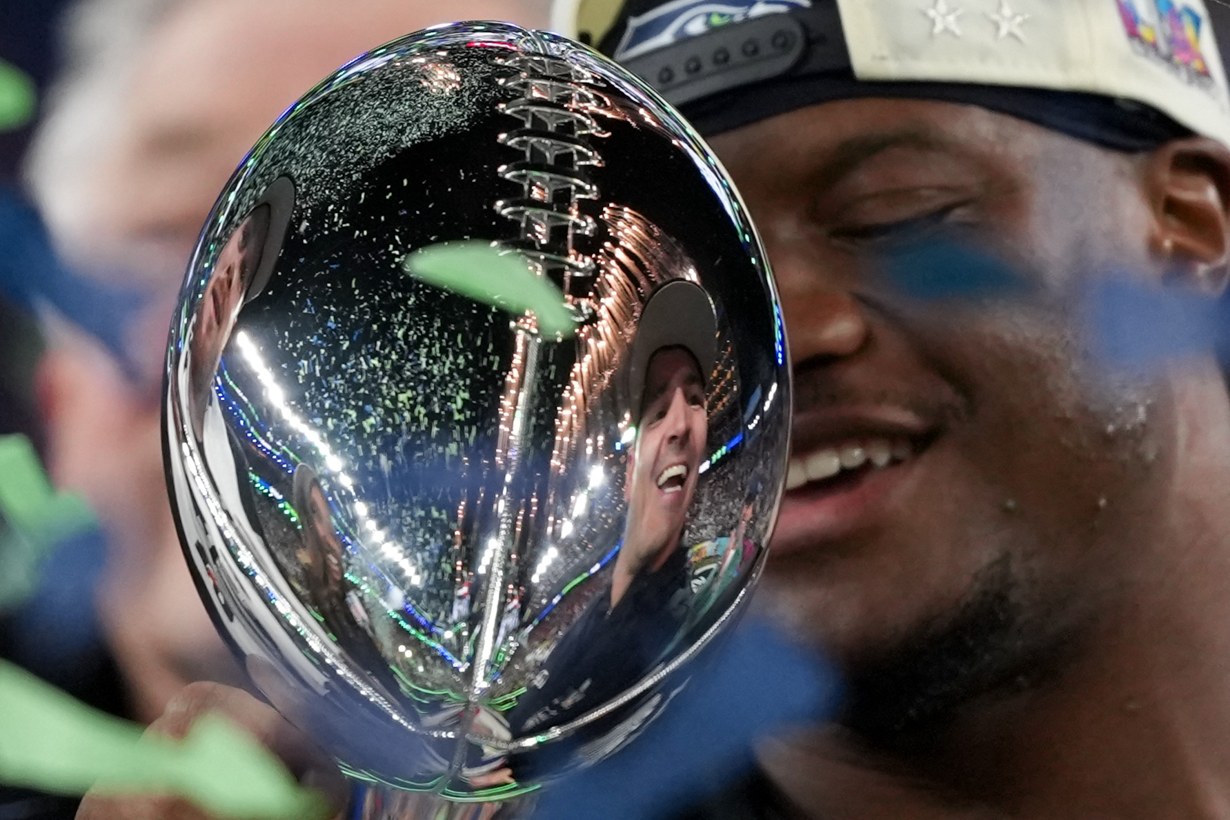 Seattle Seahawks head coach Mike MacDonald is reflected in the Lombardi Trophy after a win over the New England Patriots in the NFL Super Bowl 60 football game Sunday, Feb. 8, 2026, in Santa Clara, Calif.