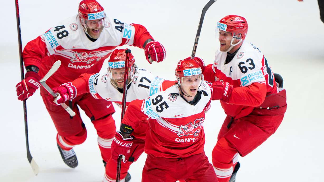 FILE - Denmark's Nick Olesen (95) celebrates with teammates after scoring the winning goal in a quarterfinal game between Canada and Denmark at the hockey world championships, May 22, 2025, in Herning, Denmark.