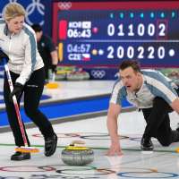 On the ice, these curlers are scowling at each other. Off the ice, they're happily married