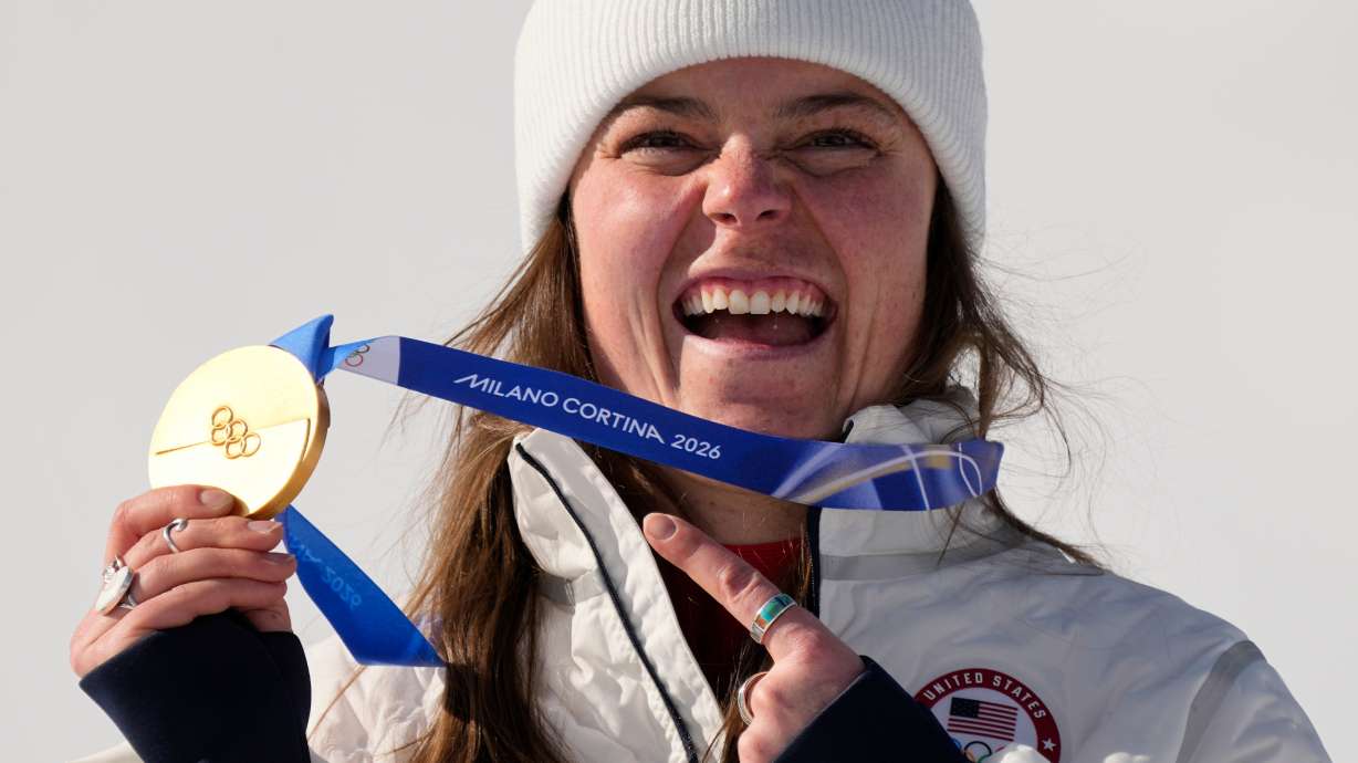United States' Breezy Johnson shows her gold medal in the alpine ski women's downhill race, at the 2026 Winter Olympics, in Cortina d'Ampezzo, Italy, Sunday, Feb. 8, 2026.