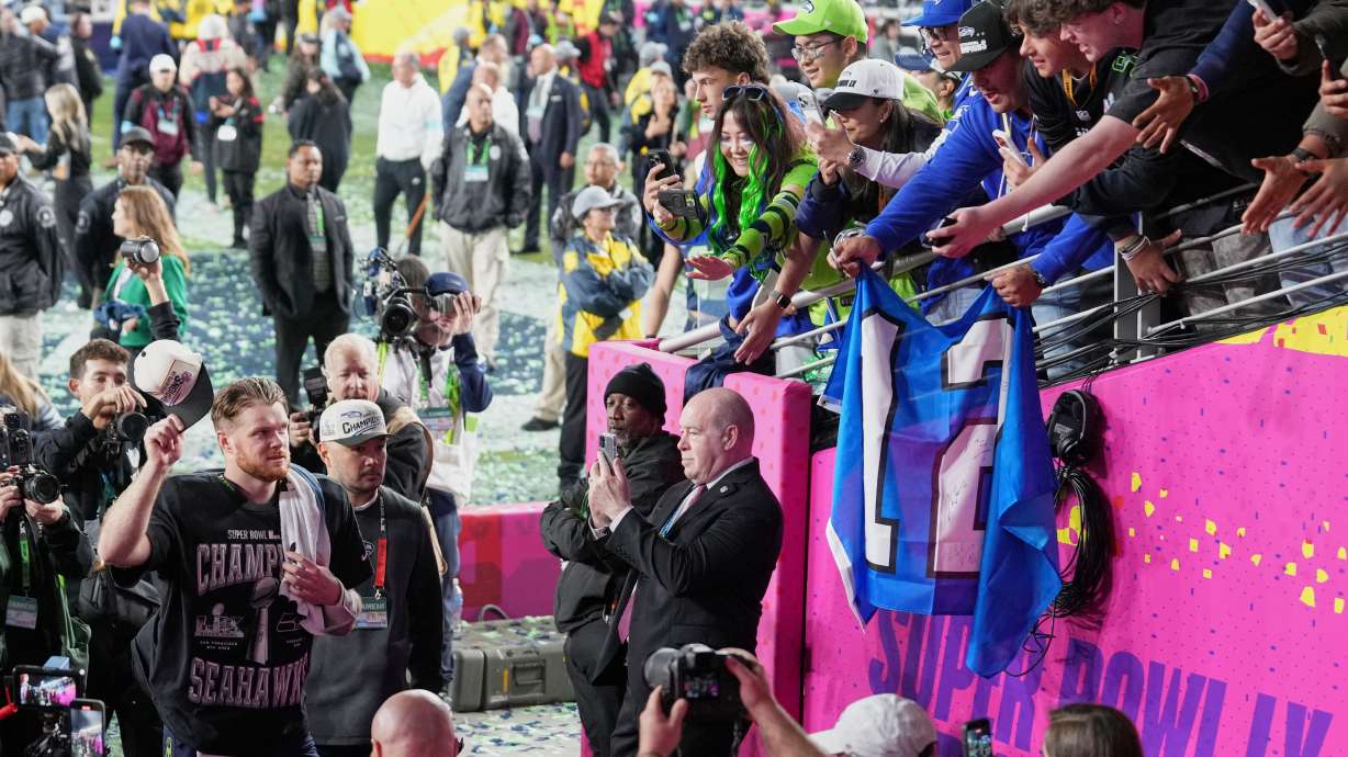 Seattle Seahawks quarterback Sam Darnold, left, celebrates as he walks off the field after winning the NFL Super Bowl 60 football game against the New England Patriots, Sunday, Feb. 8, 2026, in Santa Clara, Calif.