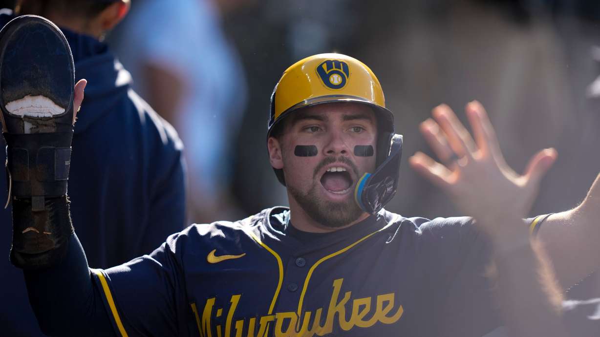 FILE - Milwaukee Brewers' Caleb Durbin celebrates after scoring against the Los Angeles Dodgers during the second inning in Game 3 of baseball's National League Championship Series, Oct. 16, 2025, in Los Angeles.