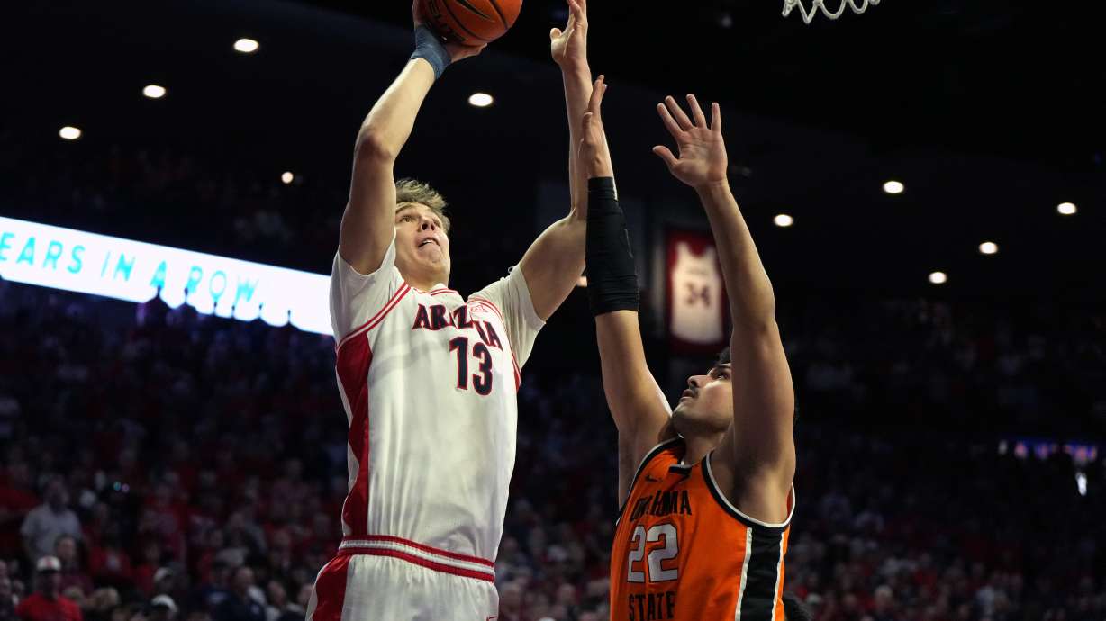 Arizona center Motiejus Krivas (13) shoots over Oklahoma State center Parsa Fallah during the first half of an NCAA college basketball game, Saturday, Feb. 7, 2026, in Tucson, Ariz.