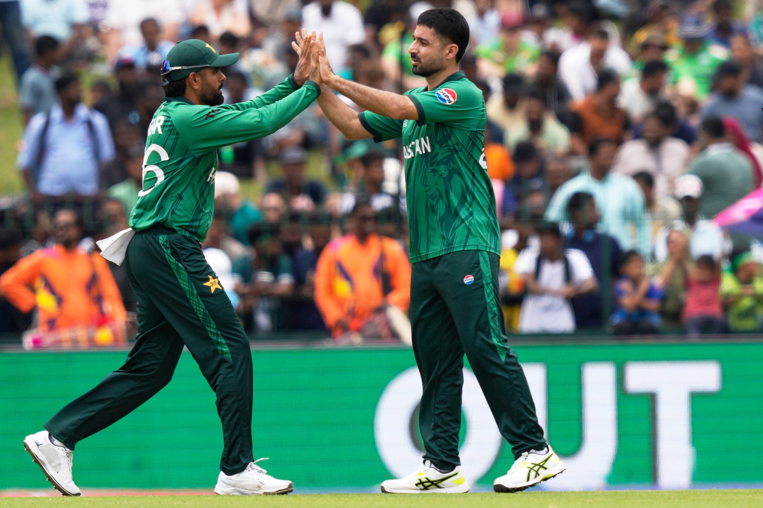 Pakistan's Abrar Ahmed, right, and teammate Babar Azam celebrate the wicket of Netherlands' captain Scott Edwards during the T20 World Cup cricket match between Netherlands and Pakistan in Colombo, Sri Lanka, Saturday, Feb. 7, 2026. 