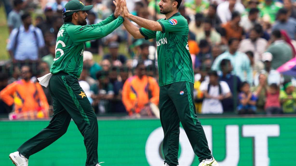 Pakistan's Abrar Ahmed, right, and teammate Babar Azam celebrate the wicket of Netherlands' captain Scott Edwards during the T20 World Cup cricket match between Netherlands and Pakistan in Colombo, Sri Lanka, Saturday, Feb. 7, 2026.