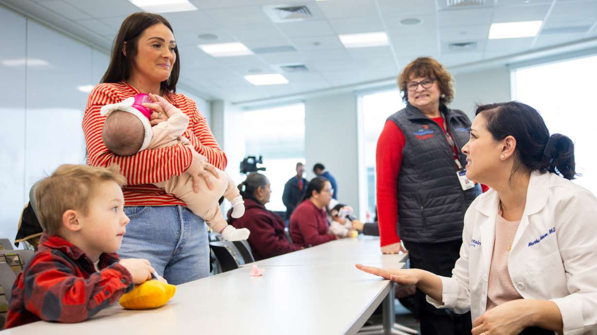 Maddison Vance, center left, holds her daughter Jaycie, 4 months, as she talks with Dr. Martha Monson, right, after a media event highlighting advancements in treatment of spina bifida at Primary Children’s Hospital on Monday.