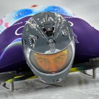 Ukrainian trains in helmet honoring fellow athletes killed in war. IOC says it's banned for race