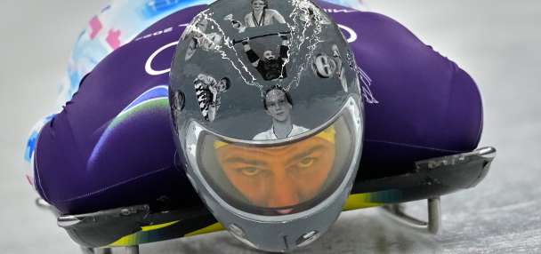 Ukrainian trains in helmet honoring fellow athletes killed in war. IOC says it's banned for race