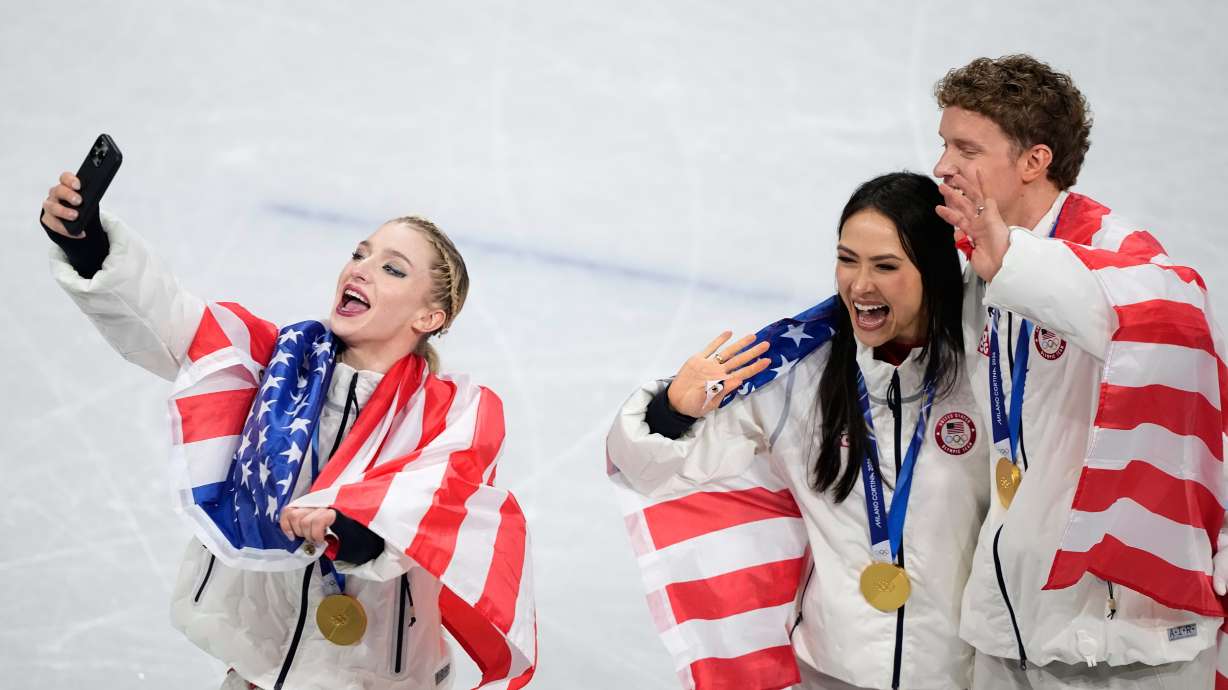 From left, Amber Glenn and ice dance team Madison Chock and Evan Bates celebrate winning the gold medal after the figure skating team event at the 2026 Winter Olympics, in Milan, Italy, Sunday, Feb. 8, 2026.