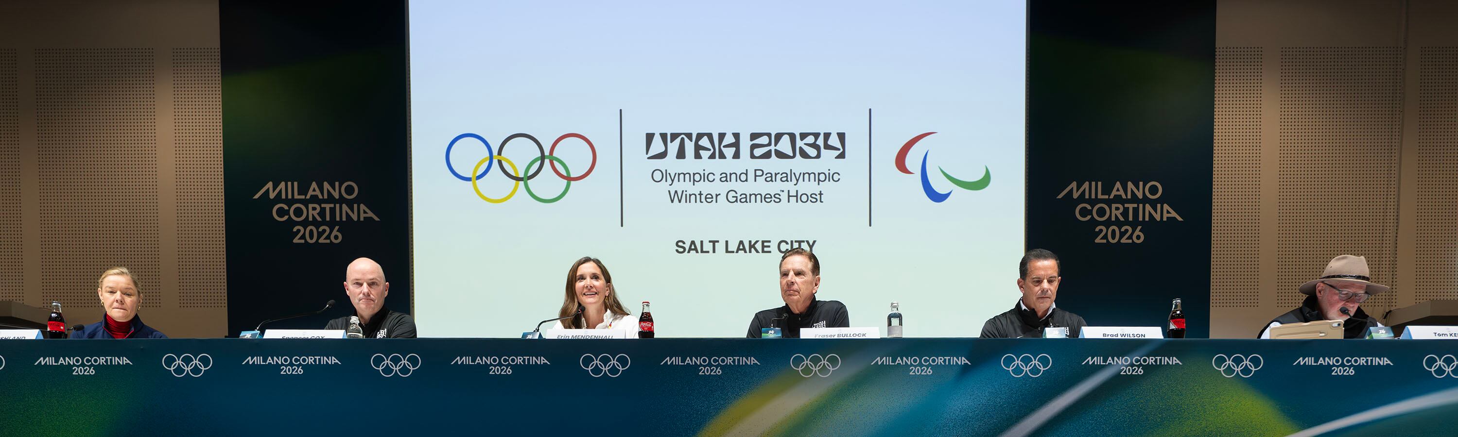 Sarah Hirshland, CEO of the U.S. Olympic and Paralympic Committee; Utah Gov. Spencer Cox; Salt Lake City Mayor Erin Mendenhall; Fraser Bullock, executive chairman and president of the Olympic Winter Games Utah 2034; and Brad Wilson, CEO of the Organizing Committee for the 2034 Olympic and Paralympic Winter Games, participate in a press conference in the main media center for the 2026 Milan Cortina Winter Olympics in Milan, Italy, on Tuesday, where Cox made a pointed call to focus on sports, not politics, at the Games.