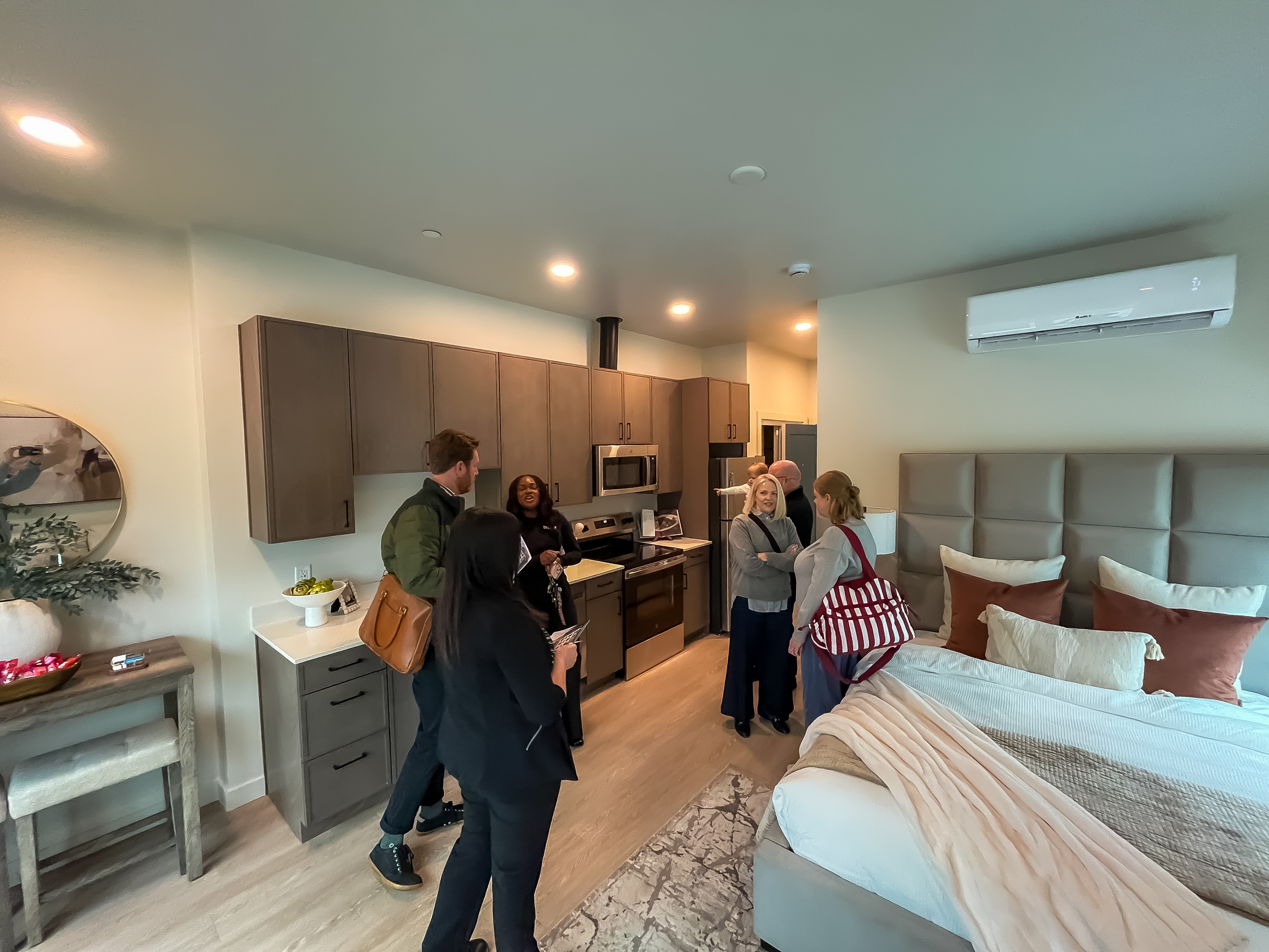 People check out the interior of a studio apartment inside Victory Heights on Tuesday. The 88-unit affordable housing complex was recently completed, creating a new use for a former medical office building.
