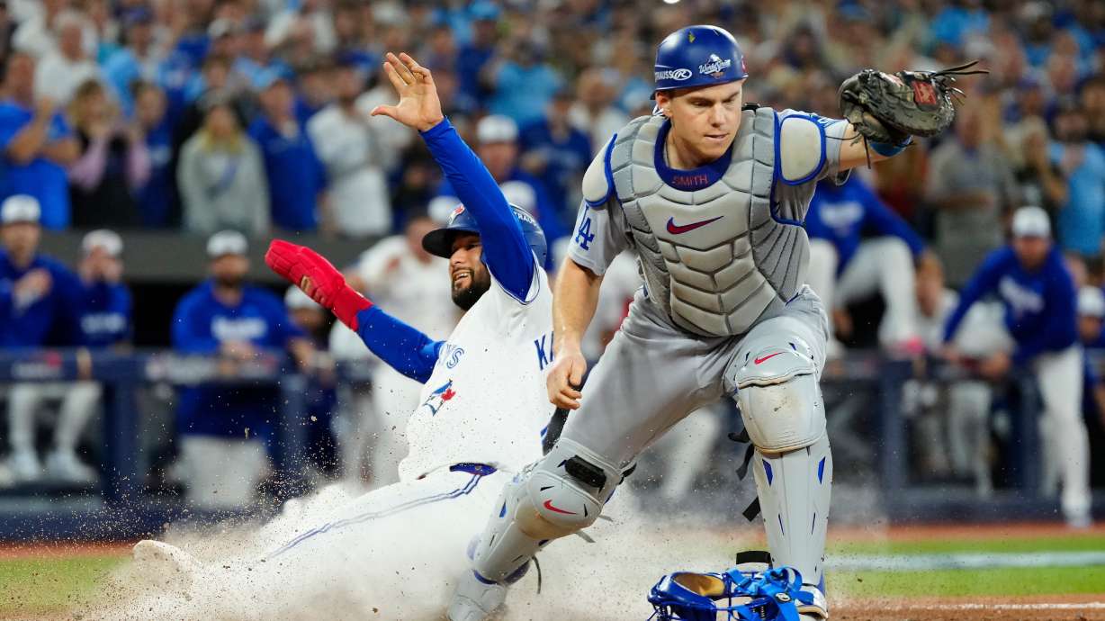 FILE - Toronto Blue Jays' Isiah Kiner-Falefa, left, is forced out at home plate by Los Angeles Dodgers catcher Will Smith during the ninth inning in Game 7 of baseball's World Series in Toronto on Nov. 1, 2025.