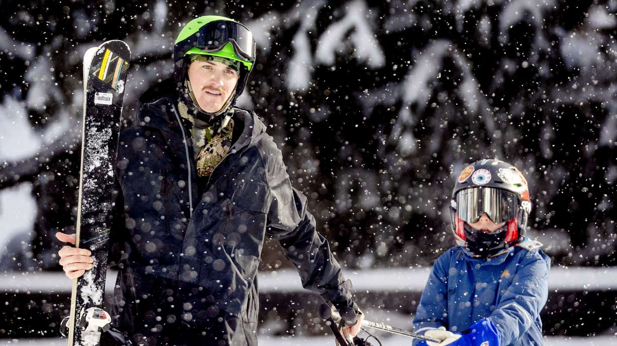 Snow falls as skiers return to the tram plaza at Snowbird in Little Cottonwood Canyon on Jan. 9. The area may receive a foot of snow or more from a system passing through Utah over the next few days.