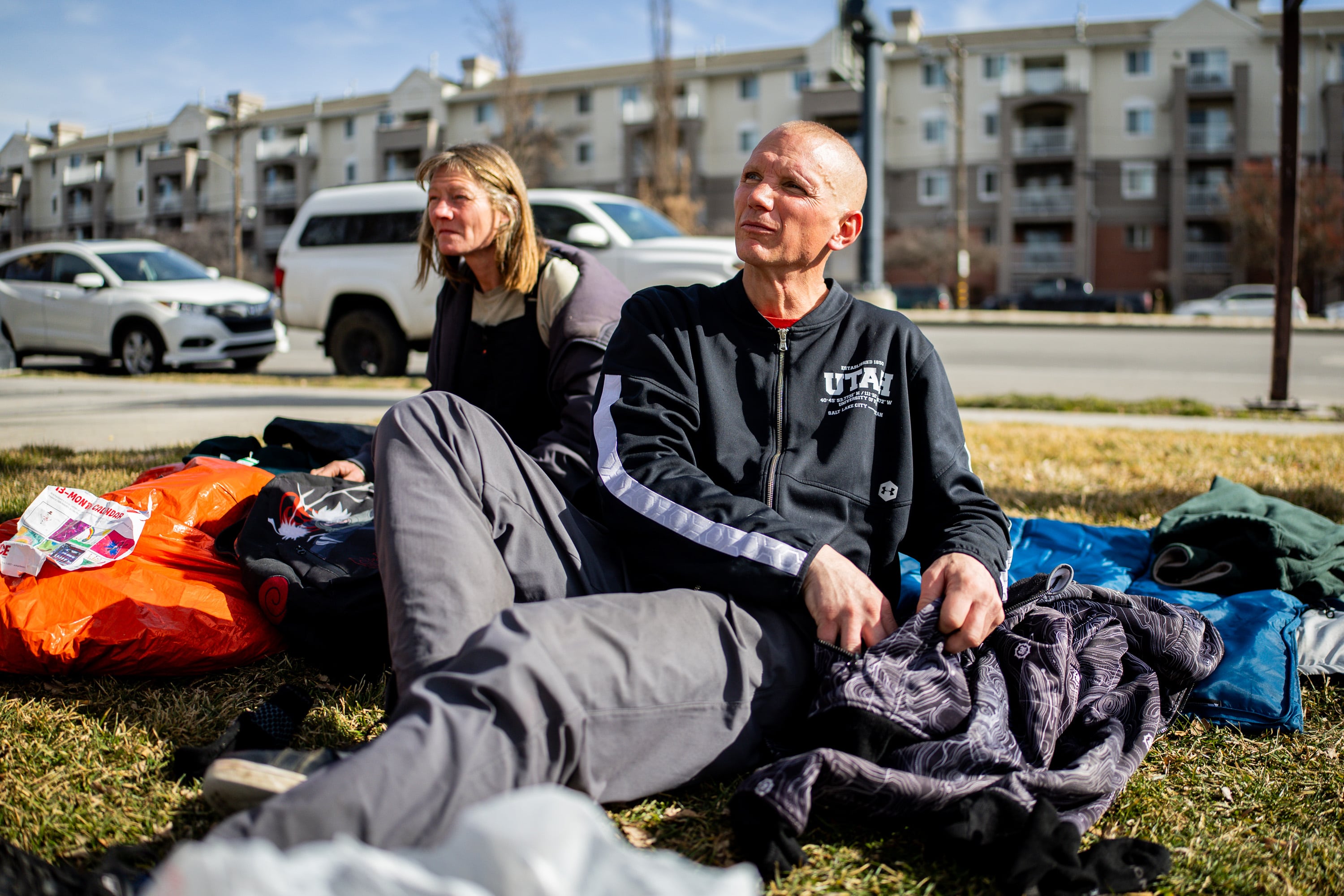 Ashley Miller, left, and Edwin Mangum, right, people experiencing homelessness, sit at Pioneer Park in Salt Lake City on Feb. 3, 2026.