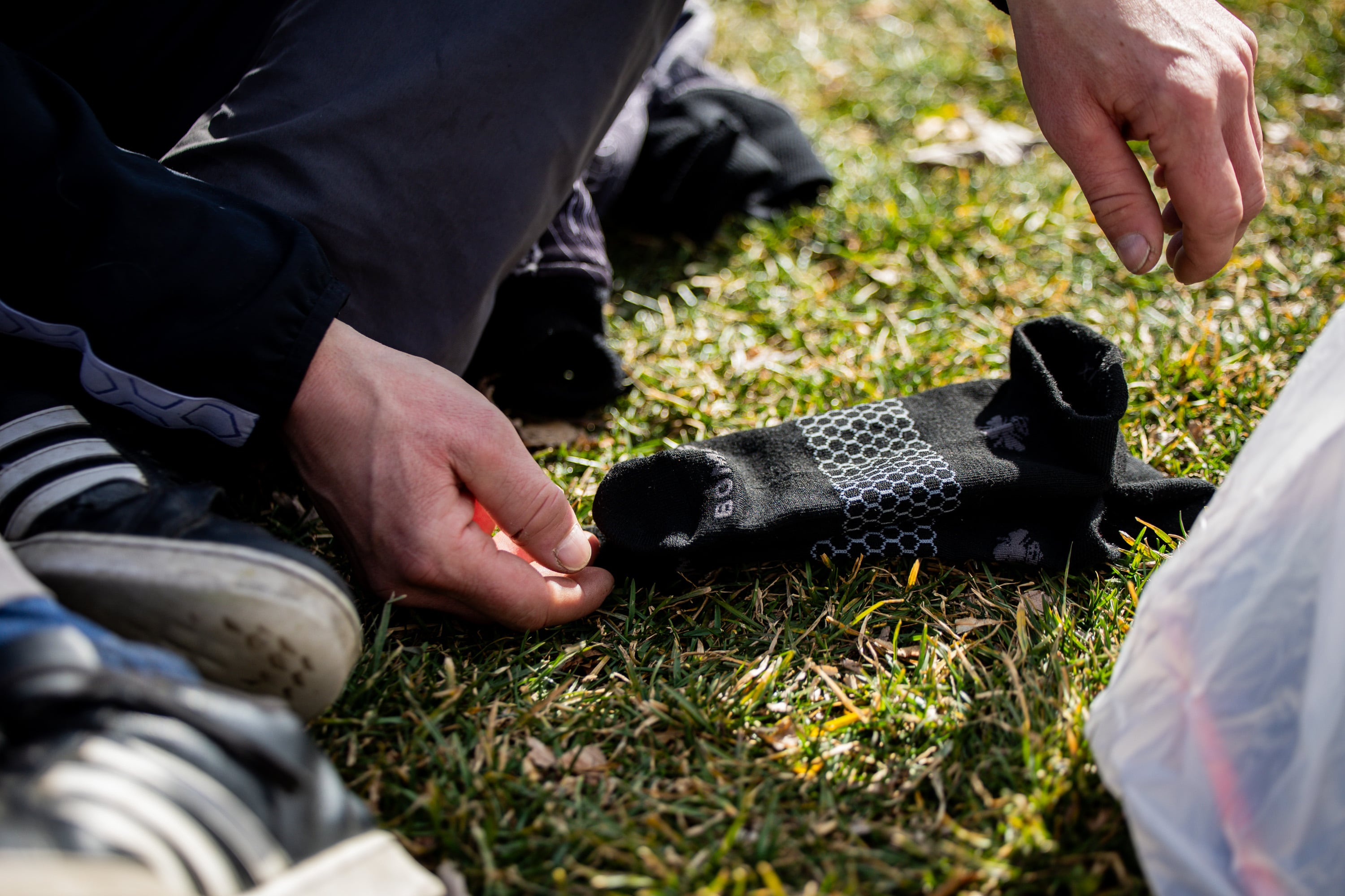 Edwin Mangum, a person experiencing homelessness, lays out his socks at Pioneer Park in Salt Lake City on Feb. 3, 2026.